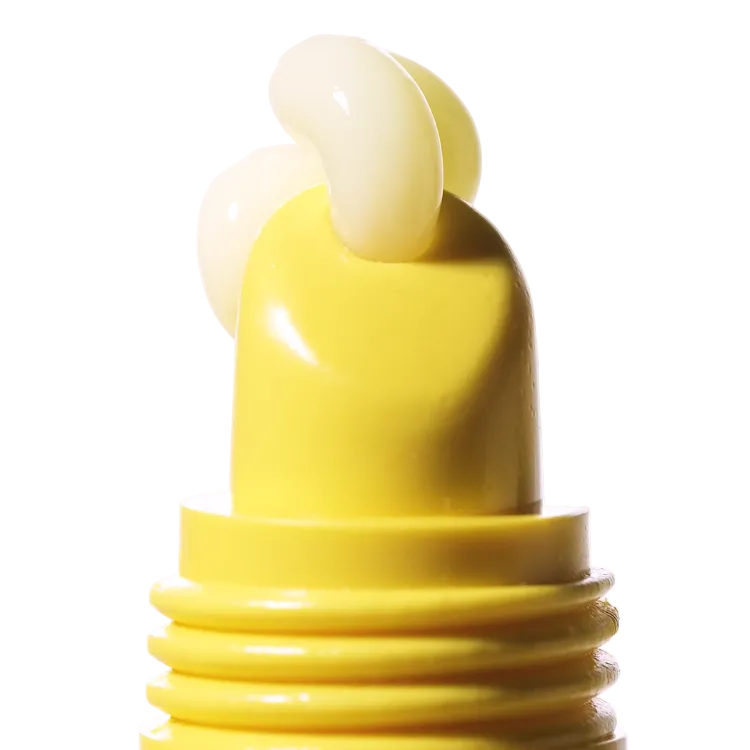 Close-up of a yellow bottle cap on a white background