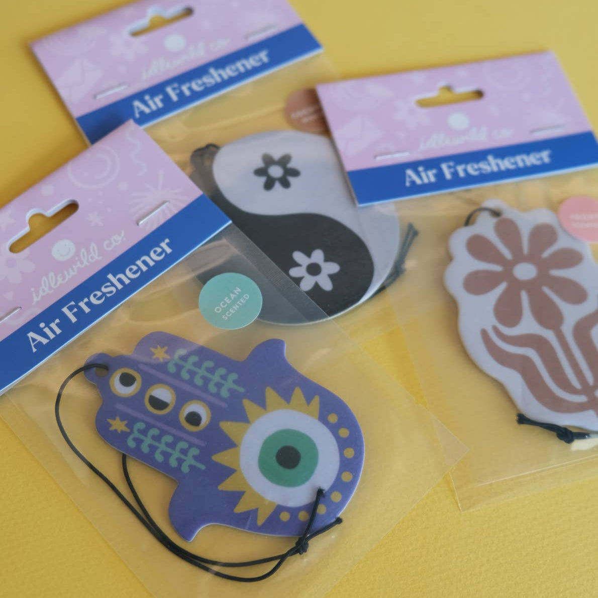 Decorative Hamsa hand pendant air feshener with colorful design on a white background
