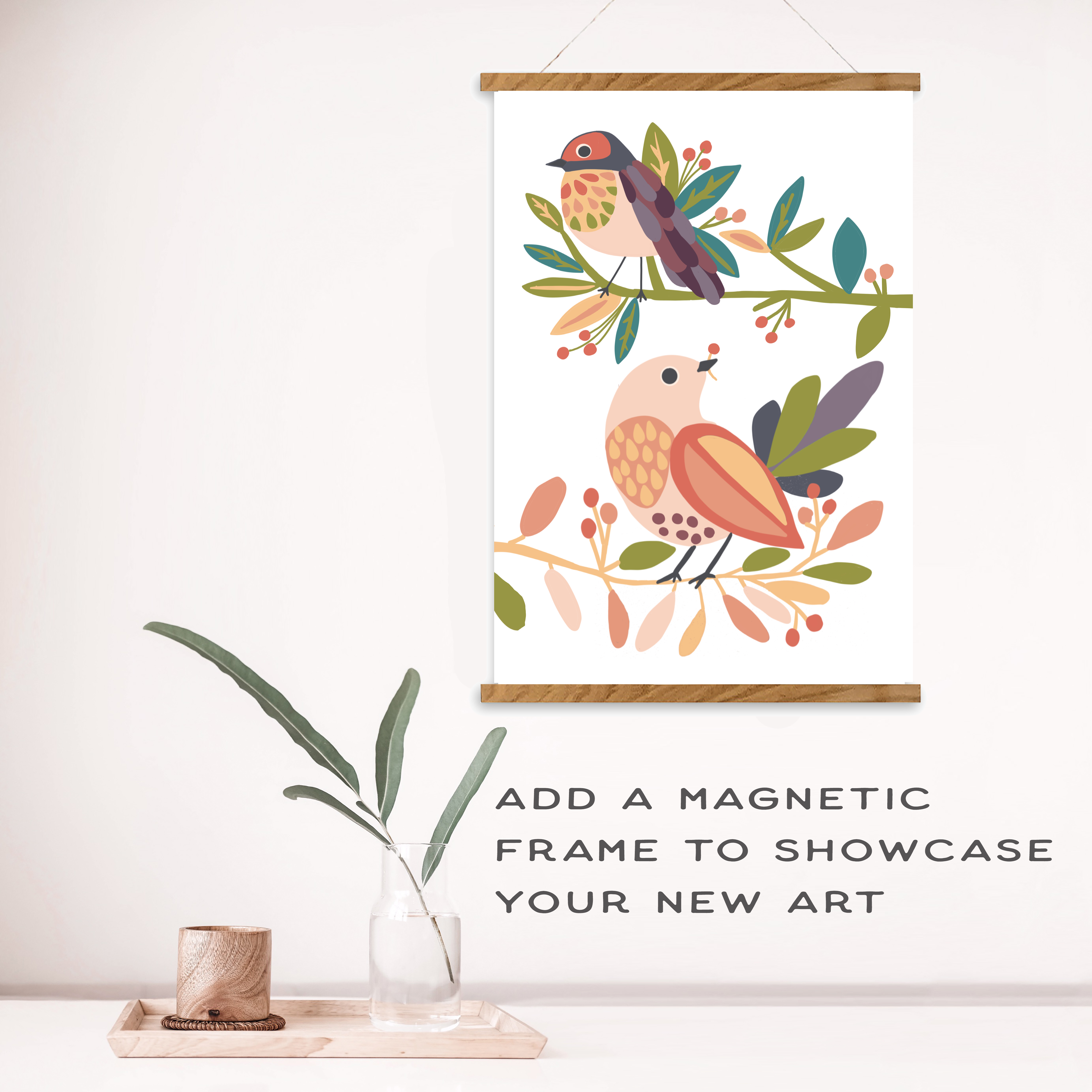 Decorative wall art with birds and foliage on a white wall, accompanied by text about a magnetic frame.