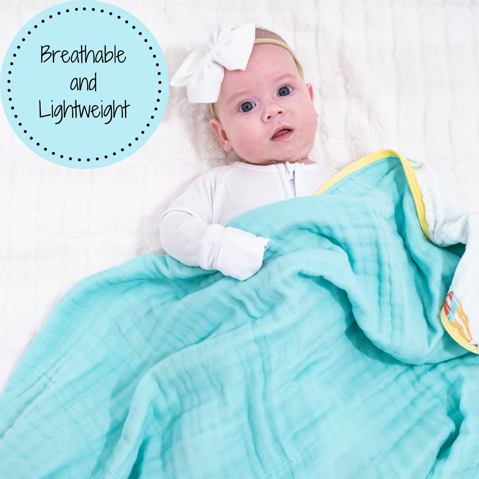 Baby wrapped in a turquoise blanket with a white bow, on a white background.