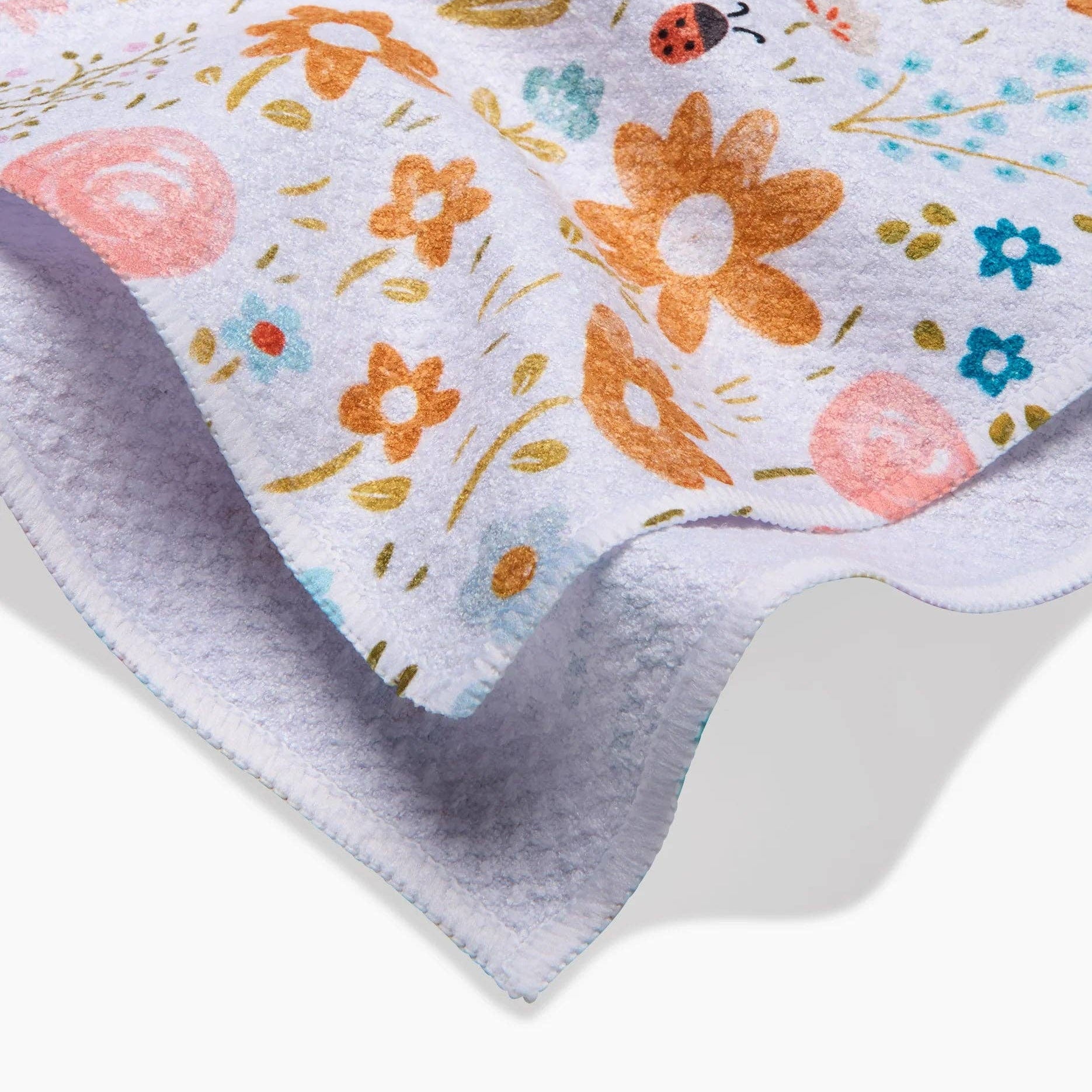 Floral patterned fabric with colorful flowers and leaves on a white background