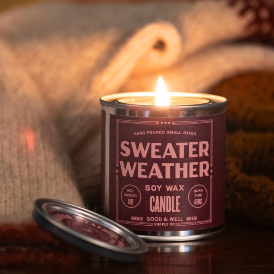 Sweater Weather candle in a can with a cozy background
