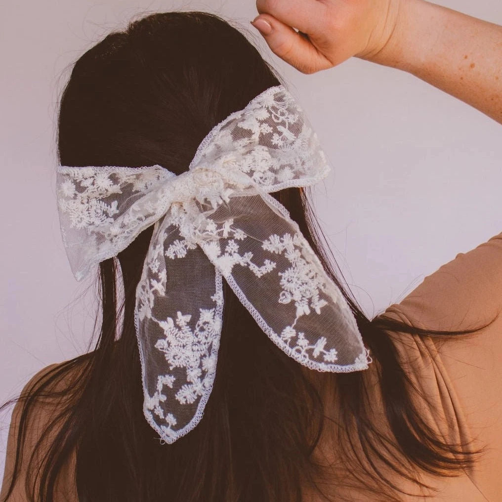 This sheer cream, lace bow, is the perfect elegant barrette for you. It has a beautiful flower lace design, a finished edge, and clips into your hair fast and easy for any updo.