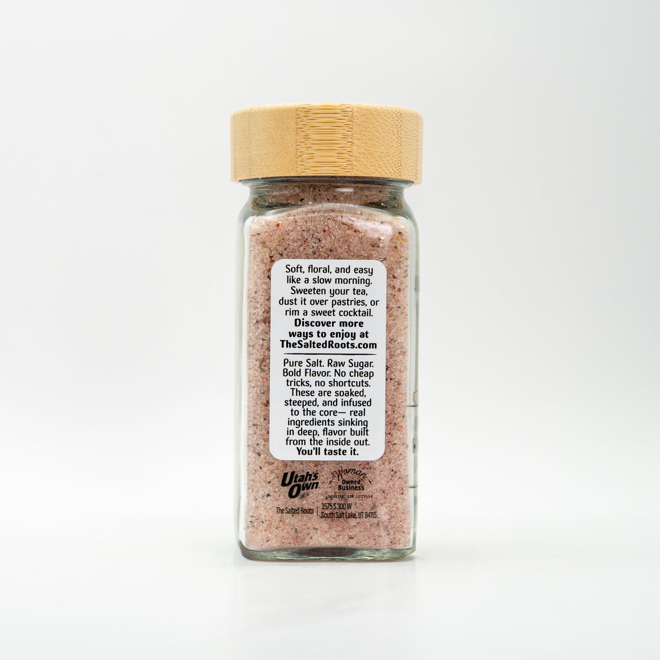 Back view of glass salt jar with wooden lid and labels.