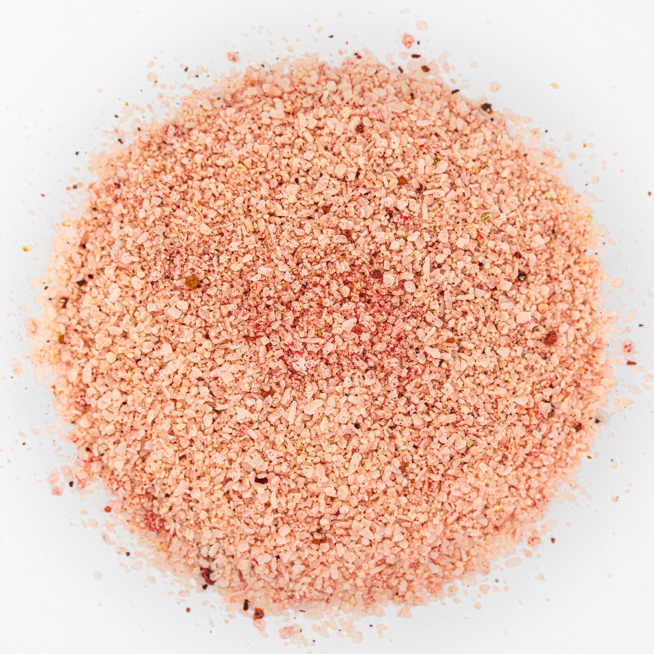 Mound of salt. Pink in color with bits of dark red.