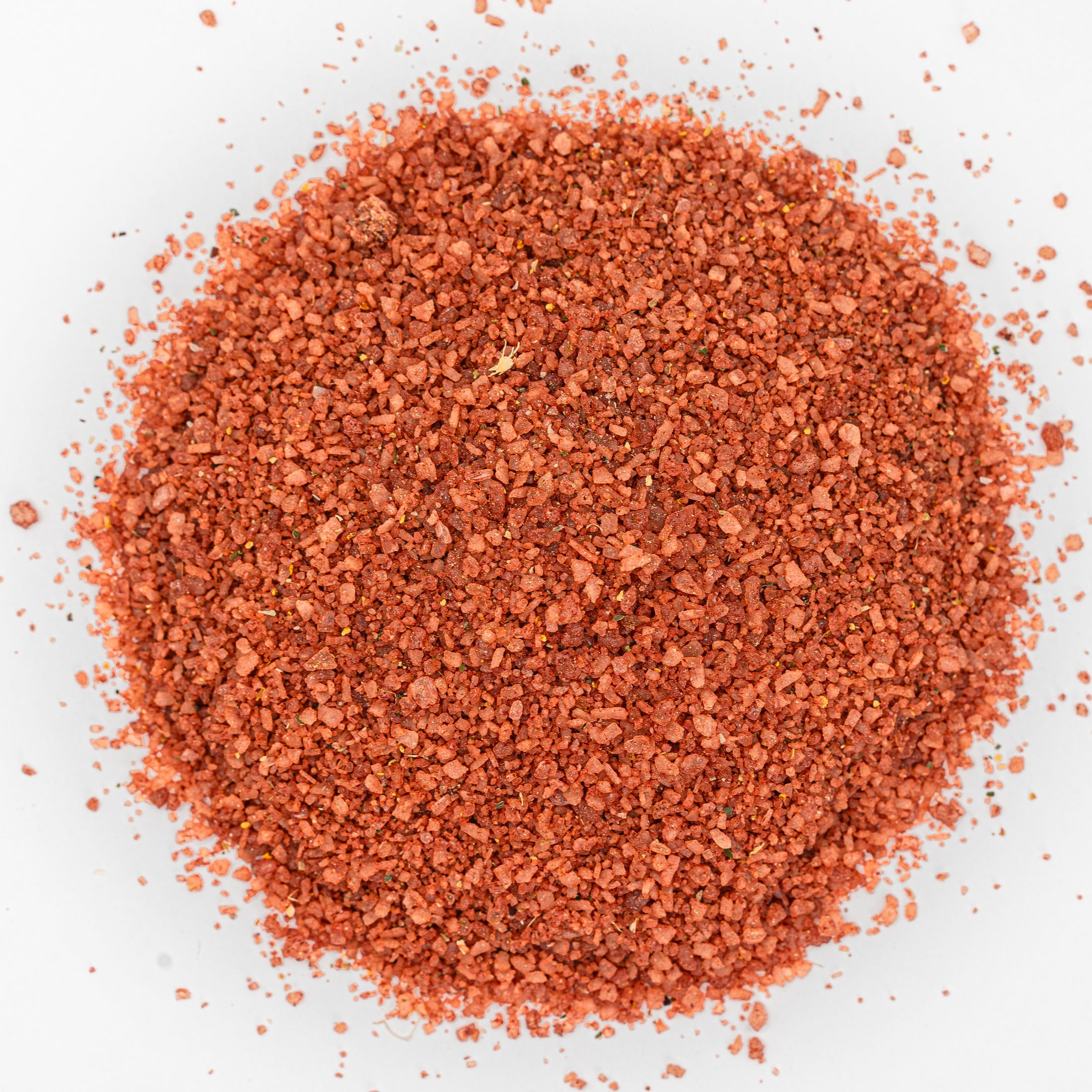Red mound of salt with flecks of herbs.