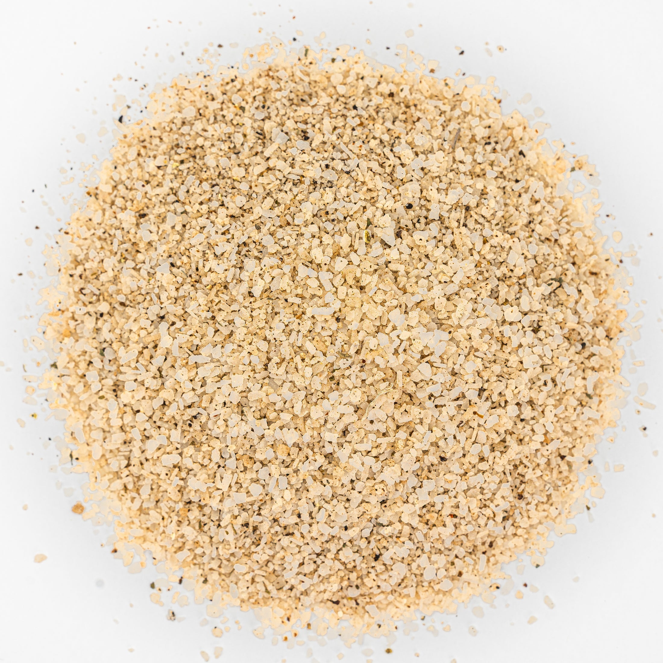 Mound of tequila salt. Beige with flecks of black.