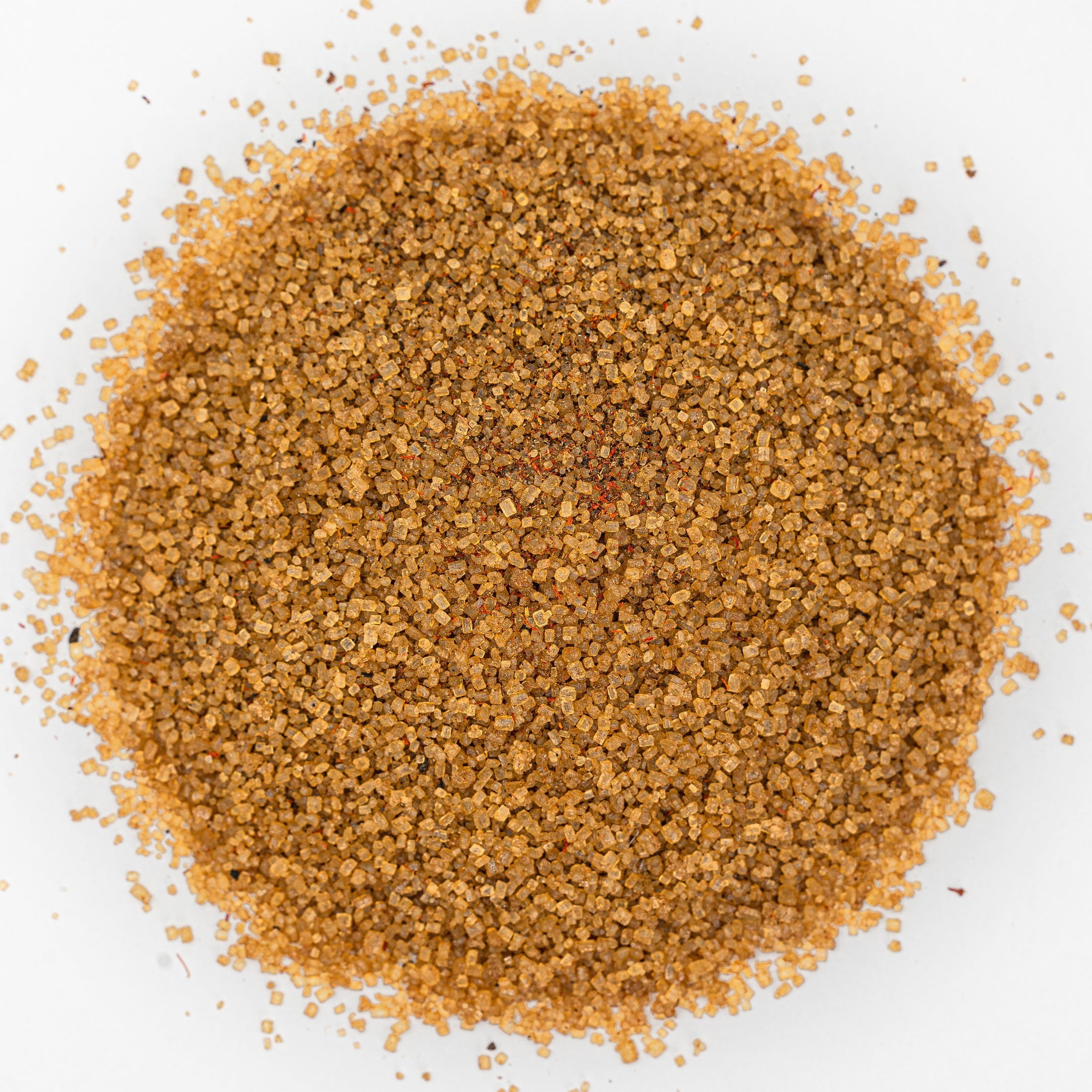 Mound of golden salt with flecks of deep orange.