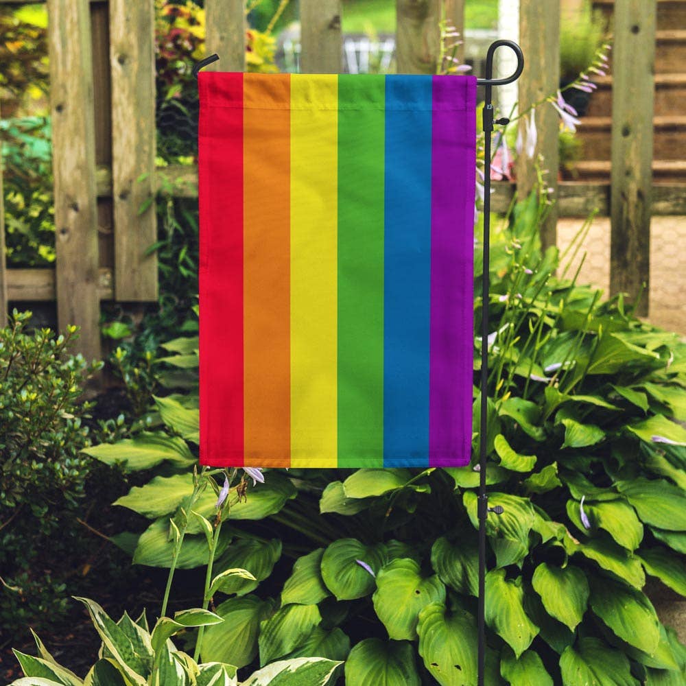Garden flag with the traditional six stripe pride flag design popularized by artist Gilbert Baker in 1978. These garden flags are a thick double-sided construction and double-stitched all around. They have a pole pocket along the top to fit any standard garden flag stake (not included). 18" x 12"