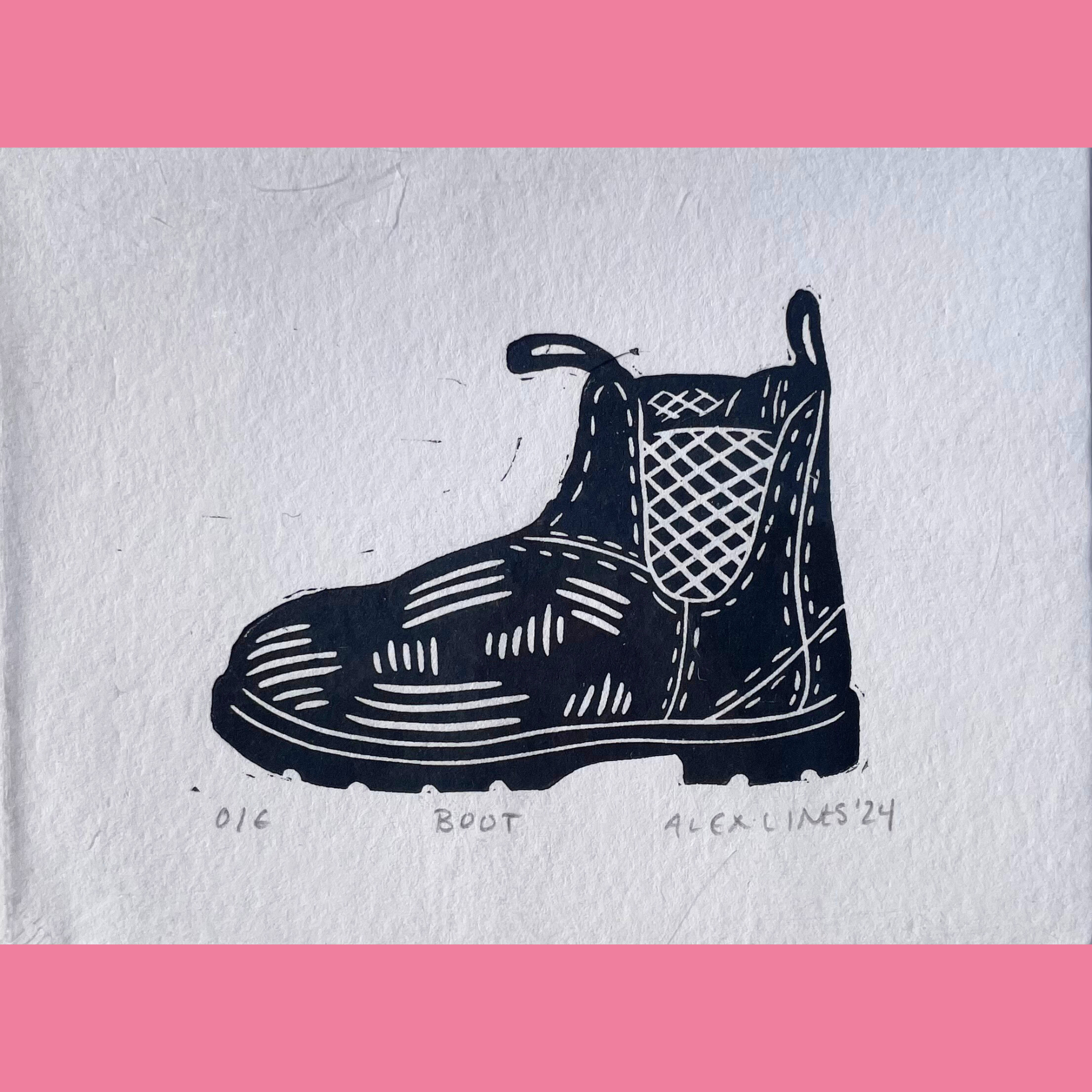 A black-and-white linocut print depicts a single sturdy work boot viewed from the side, featuring a thick lug sole, detailed laces, a pull tab at the top, and a textured grid-patterned panel on the side. The artwork is printed on white paper with the title "BOOT," the number "016," and the signature "ALEX LINTS '24" written below, and it is surrounded by a bright pink border.