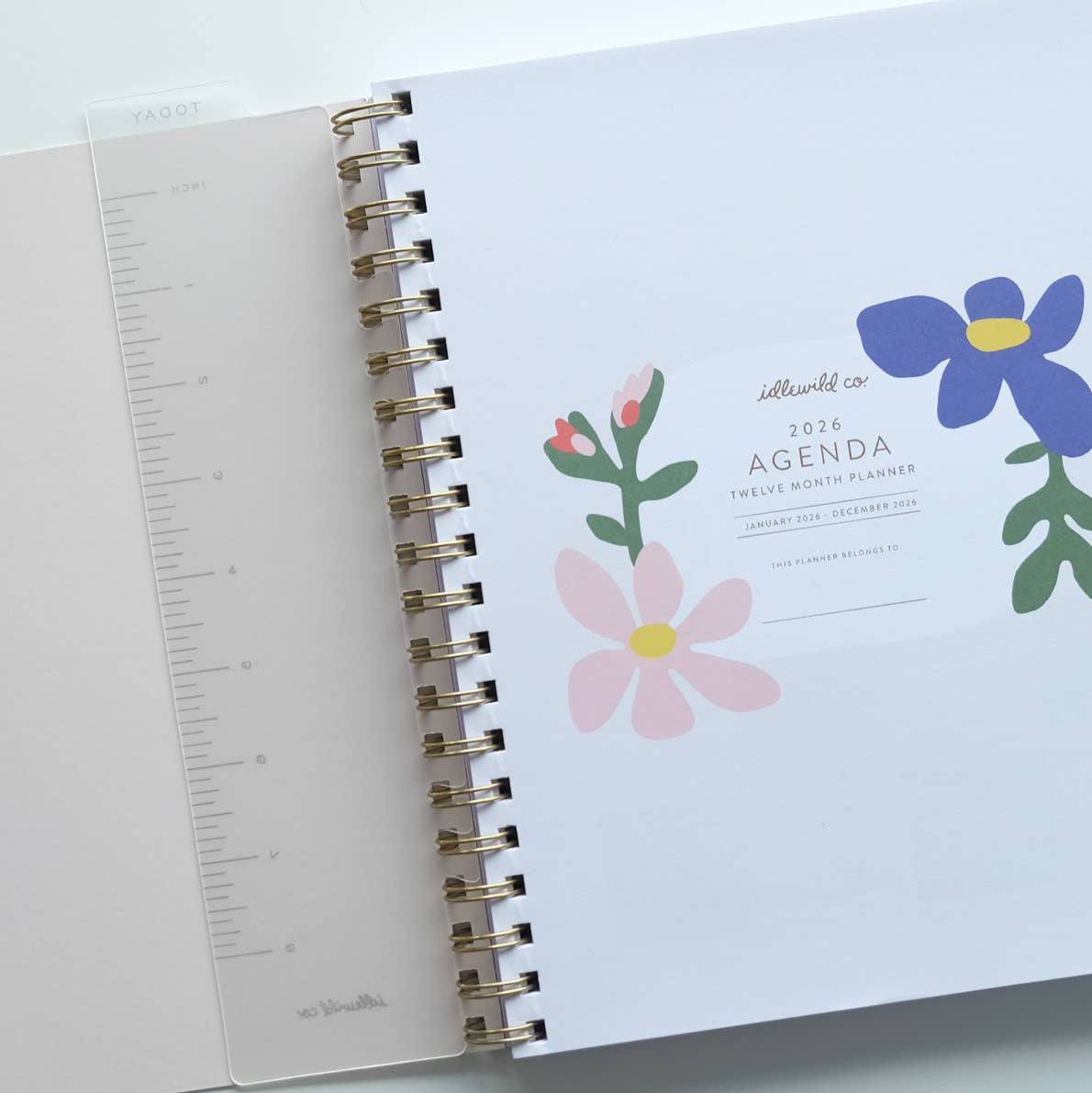 Open planner with floral design on a light blue background