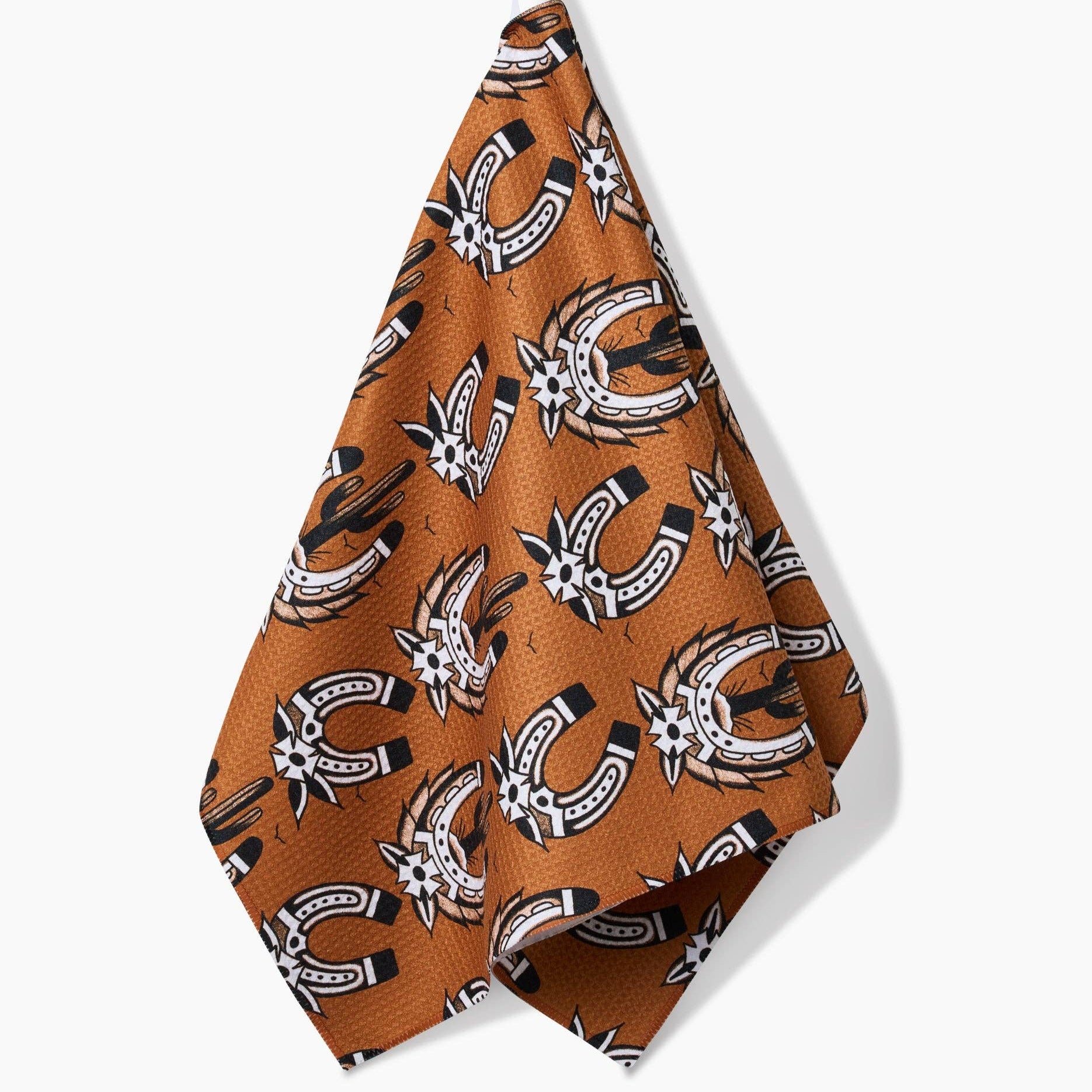 Brown towel with horseshoe pattern hanging on a white background