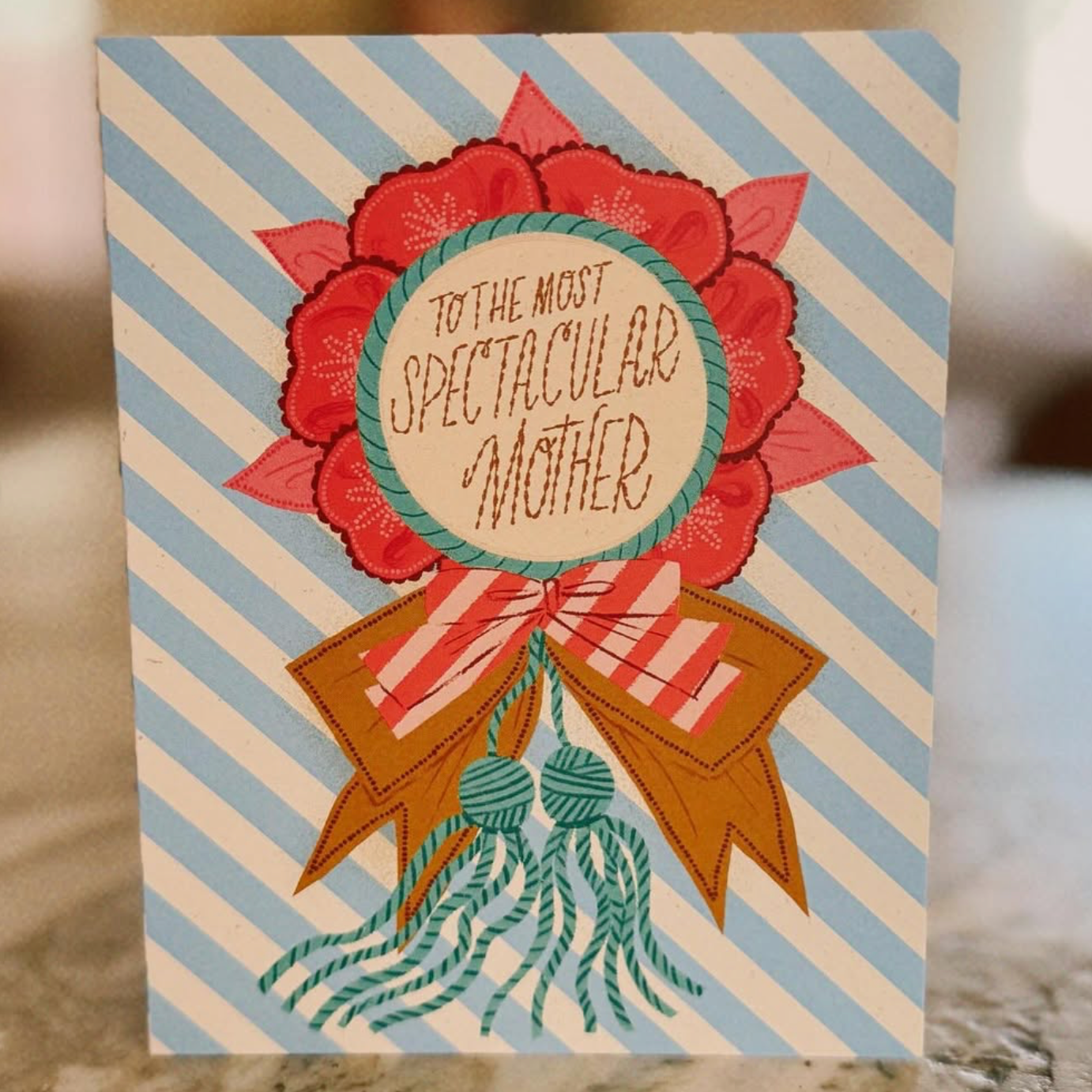 Greeting card with floral design and text on a striped background