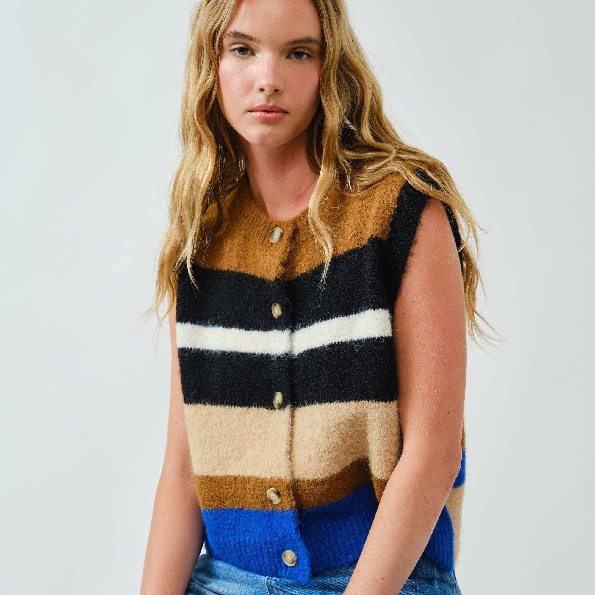 Cozy up in bold style with this soft pullover sweater vest, designed with striking multicolor stripes. The fuzzy knit texture adds warmth, while the relaxed fit and button-down front offer a laid-back, vintage-inspired feel. Whether layered over a shirt or worn on its own, this vest delivers both comfort and standout personality.
