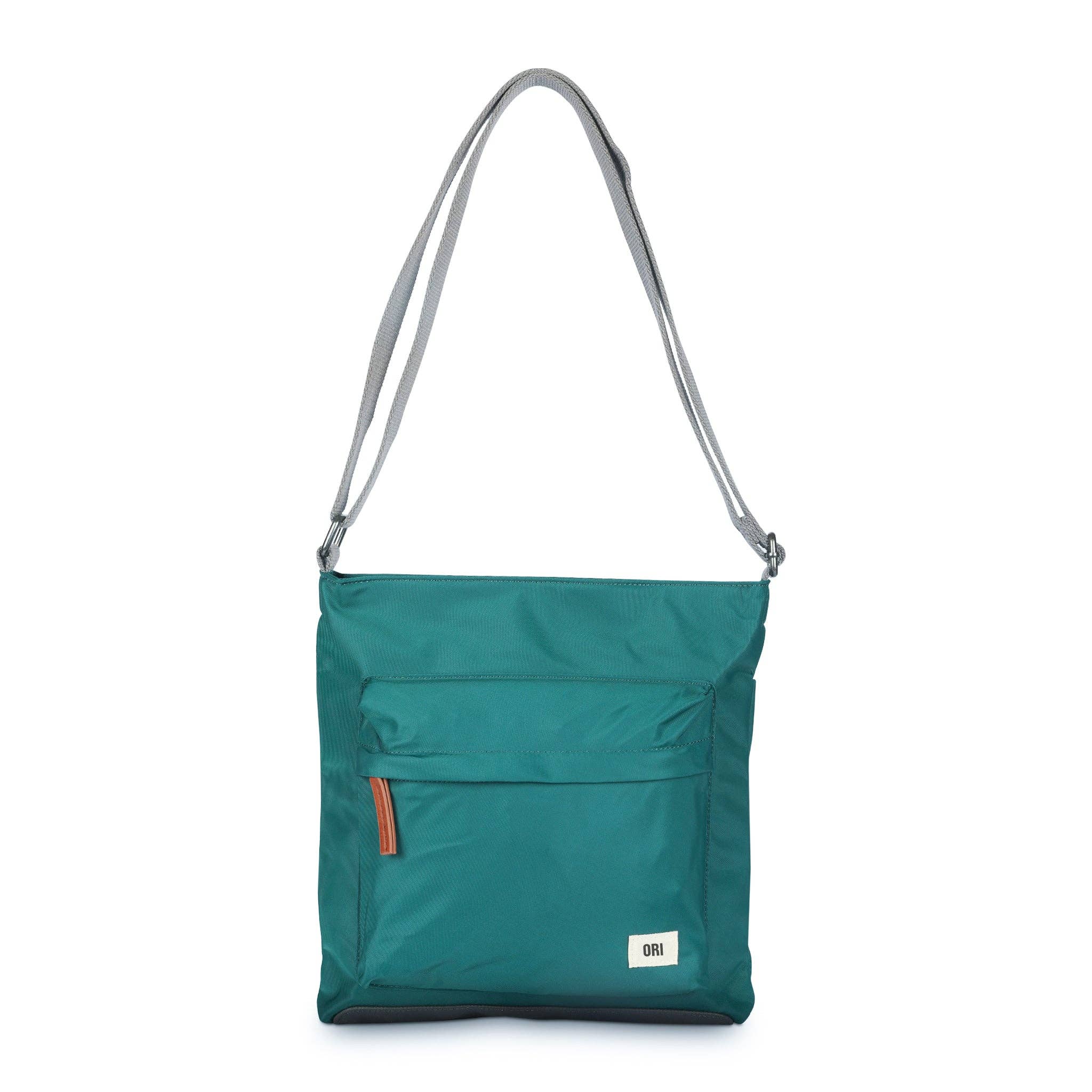 This teal crossbody bag is perfect for any occasion – effortlessly taking you from day to night! Wear on the shoulder or across the body, this bag will fit all of your essentials in it and close to hand. With a zipped pocket on the front, a pocket on the back and additional pockets on the inside, you have the perfect bag to organize all of your belongings. The bold chunky zips and weather-resistant recycled nylon material gives you a smooth look and finish to take on any day, rain or shine!