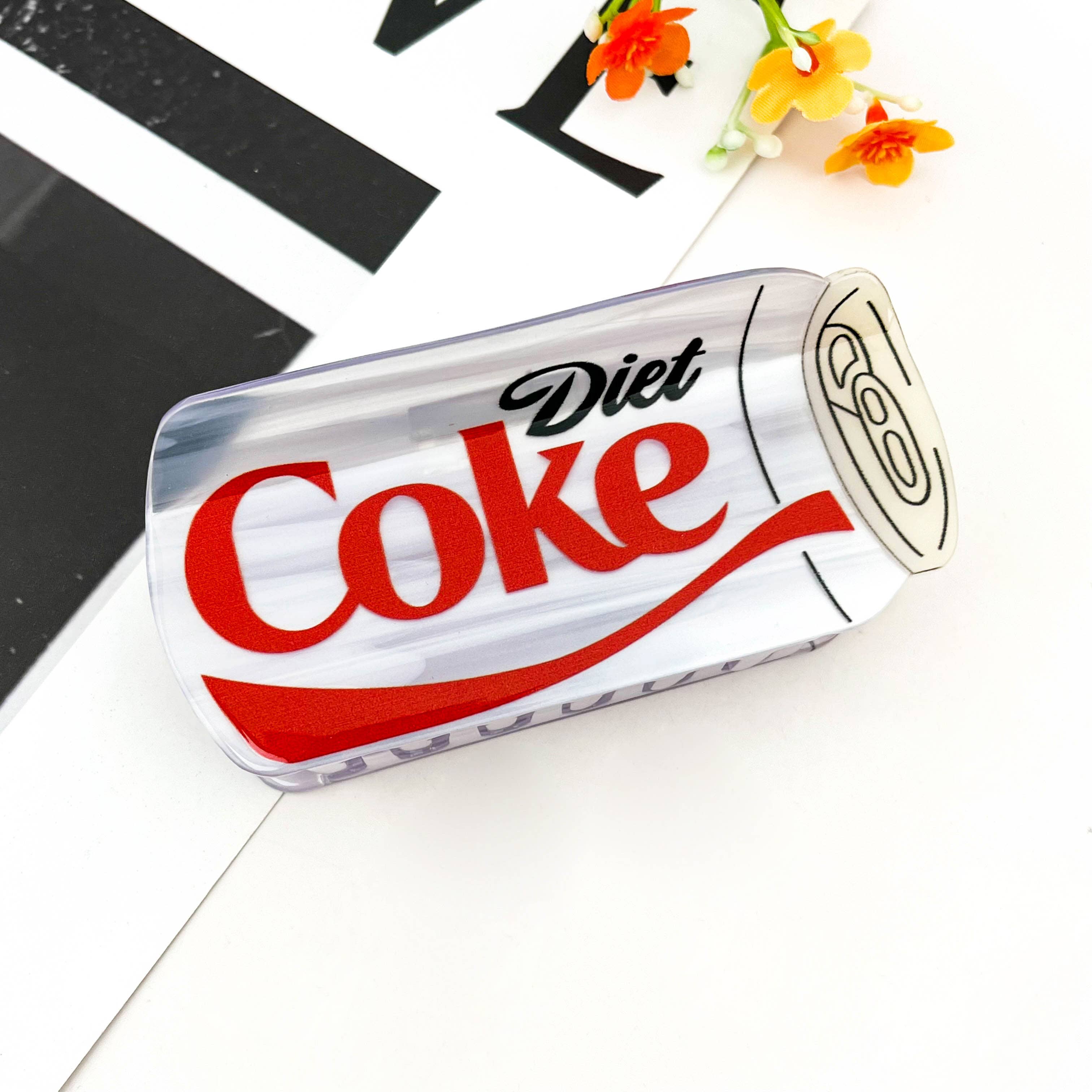 Add a playful pop to your accessory collection with this diet-coke hair claw. Its quirky design instantly catches attention, making it a fun conversation starter and a perfect match for customers who love novelty fashion.
Made from durable acetate-style material with a glossy finish, this claw clip holds hair firmly in place while keeping a lightweight and comfortable feel.