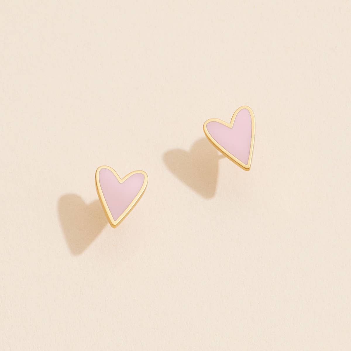 Fall in love with our Enamel Heart Shaped Stud Earrings! These charming earrings feature delicate enamel hearts that add a touch of loveliness to any outfit. Treat yourself or your loved one with these beautiful studs today!