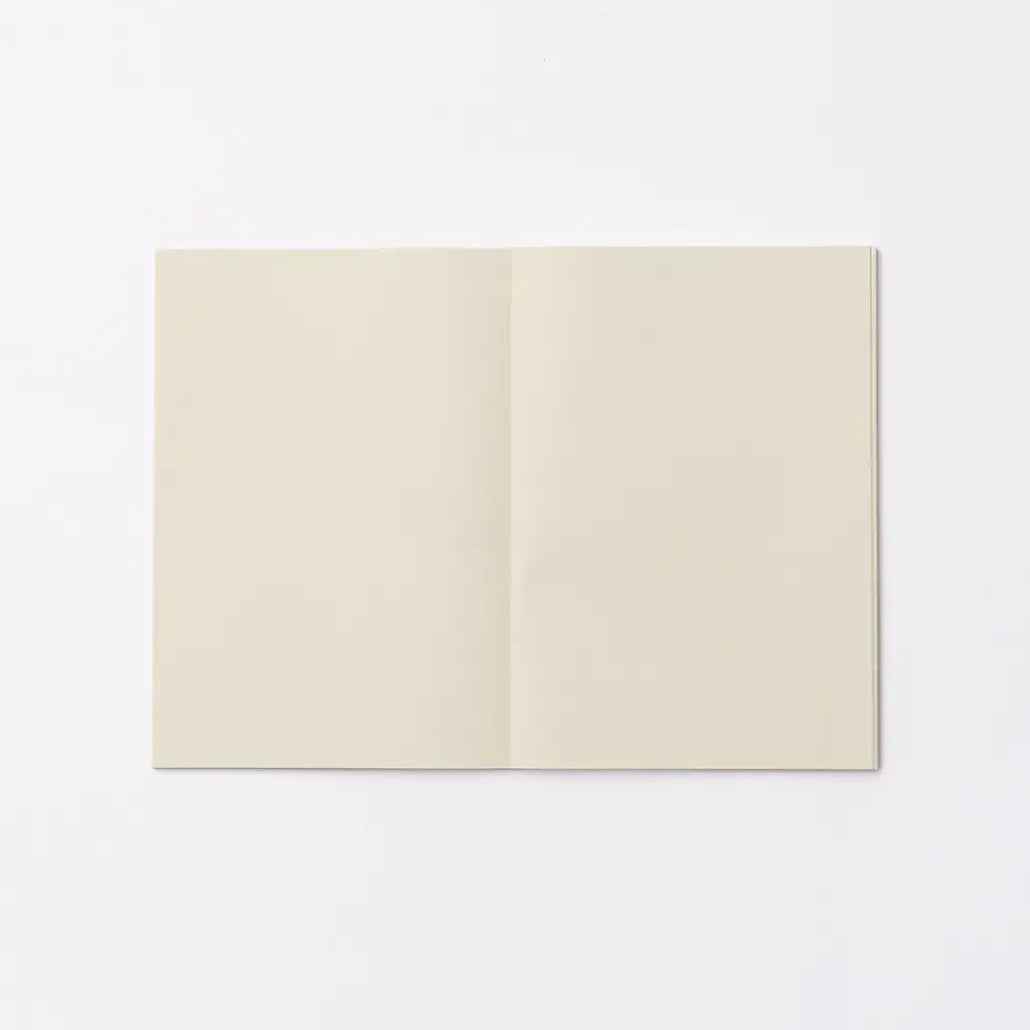 An open blank notebook with cream-colored pages, displayed flat against a clean white background.