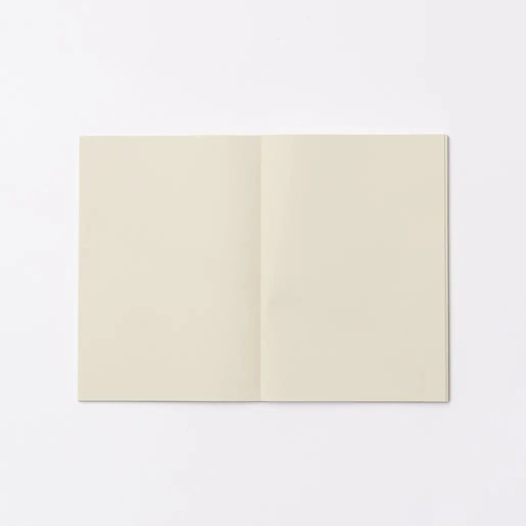 An open blank notebook with cream-colored pages, displayed flat against a clean white background.