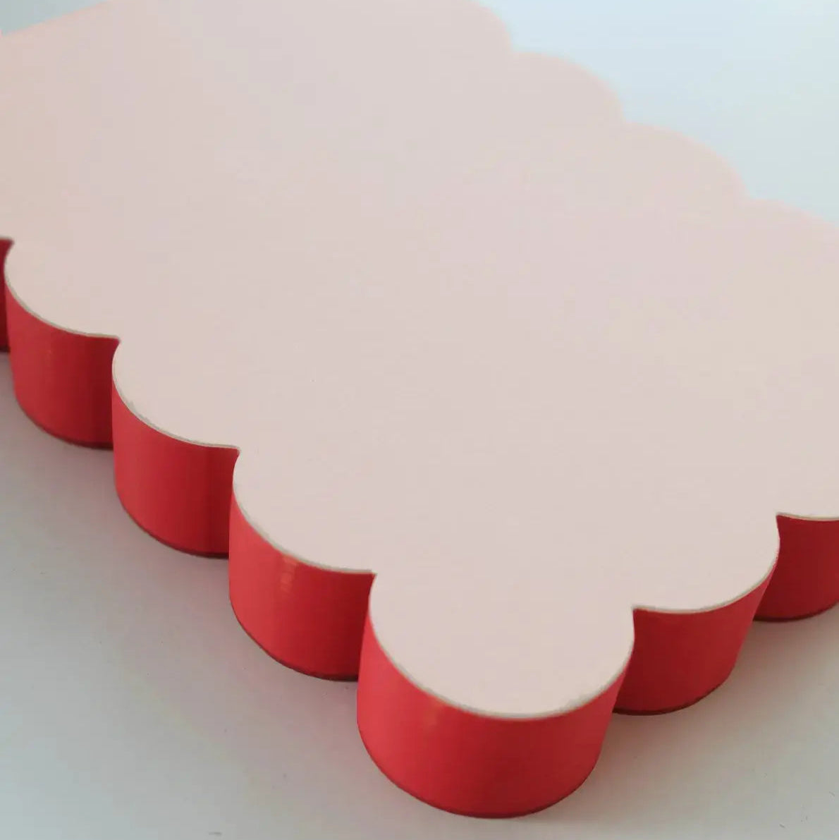 Red and beige cloud-shaped objects on a light gray background