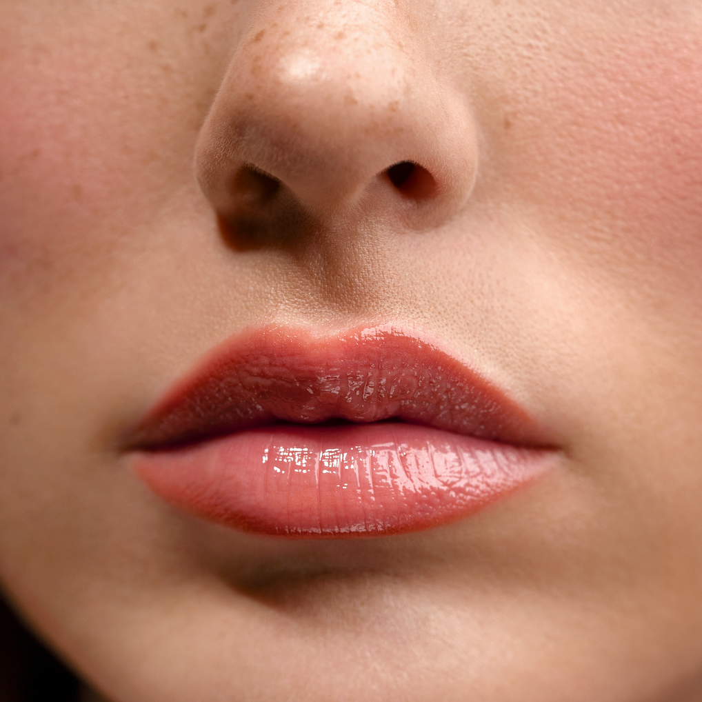 Close-up of a person's lips with a soft focus on the skin around.