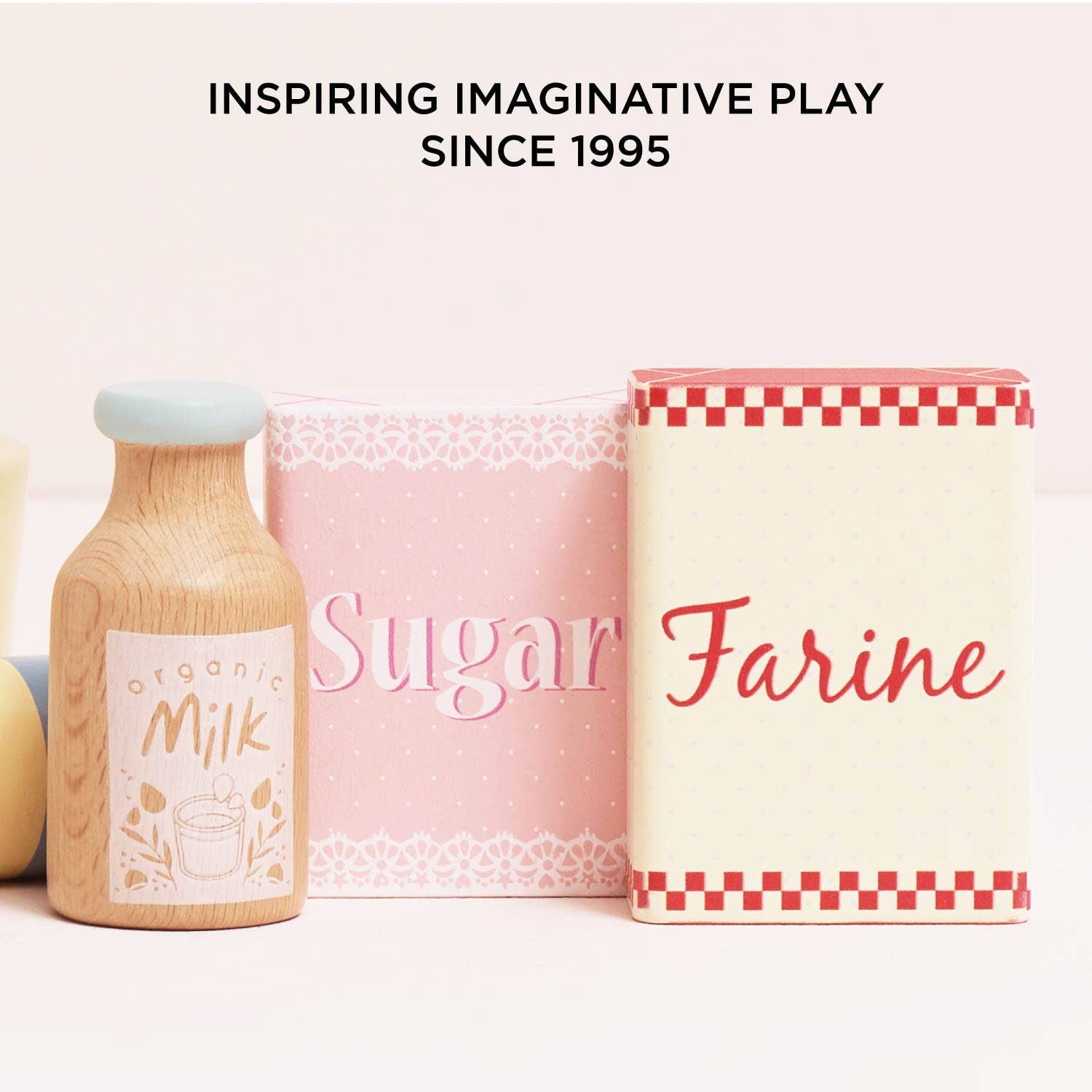 Playful kitchen set with 'Milk', 'Sugar', and 'Farine' containers on a light background.