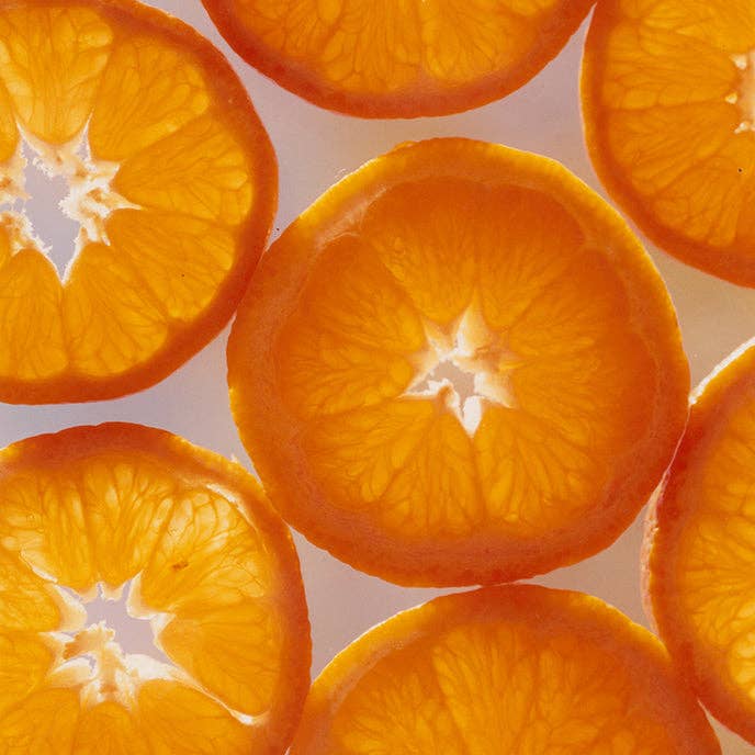 Sliced oranges arranged in a pattern on a light background