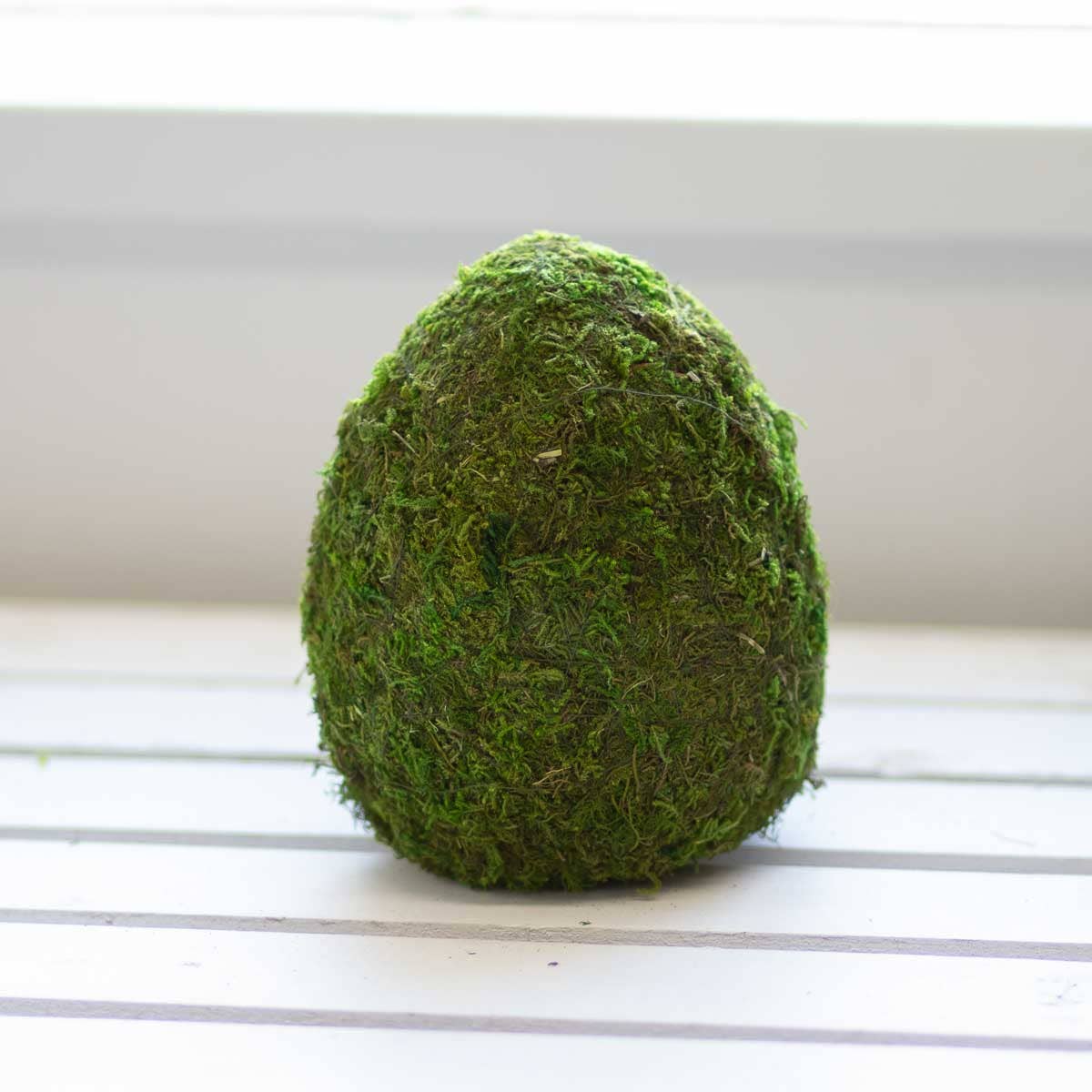 This Belmont 6.5" Egg Moss Decor Green is the perfect addition to your home decor. The beautiful green color and unique design will add a touch of nature to any room. Its lightweight and durable construction makes it easy to display anywhere, providing a sense of calm and tranquility. Elevate your home's ambiance with this lovely decorative piece
