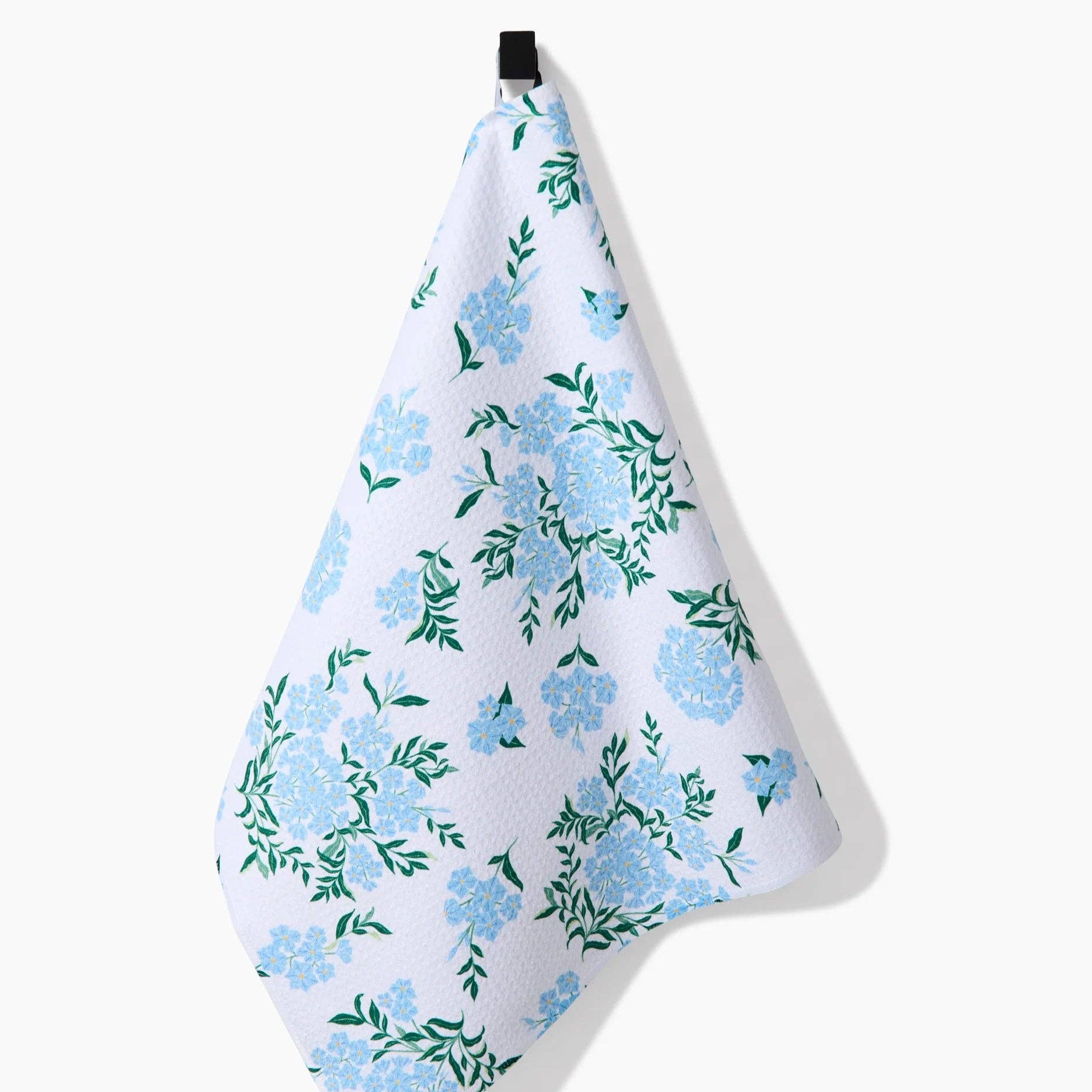 Floral patterned towel hanging on a white background