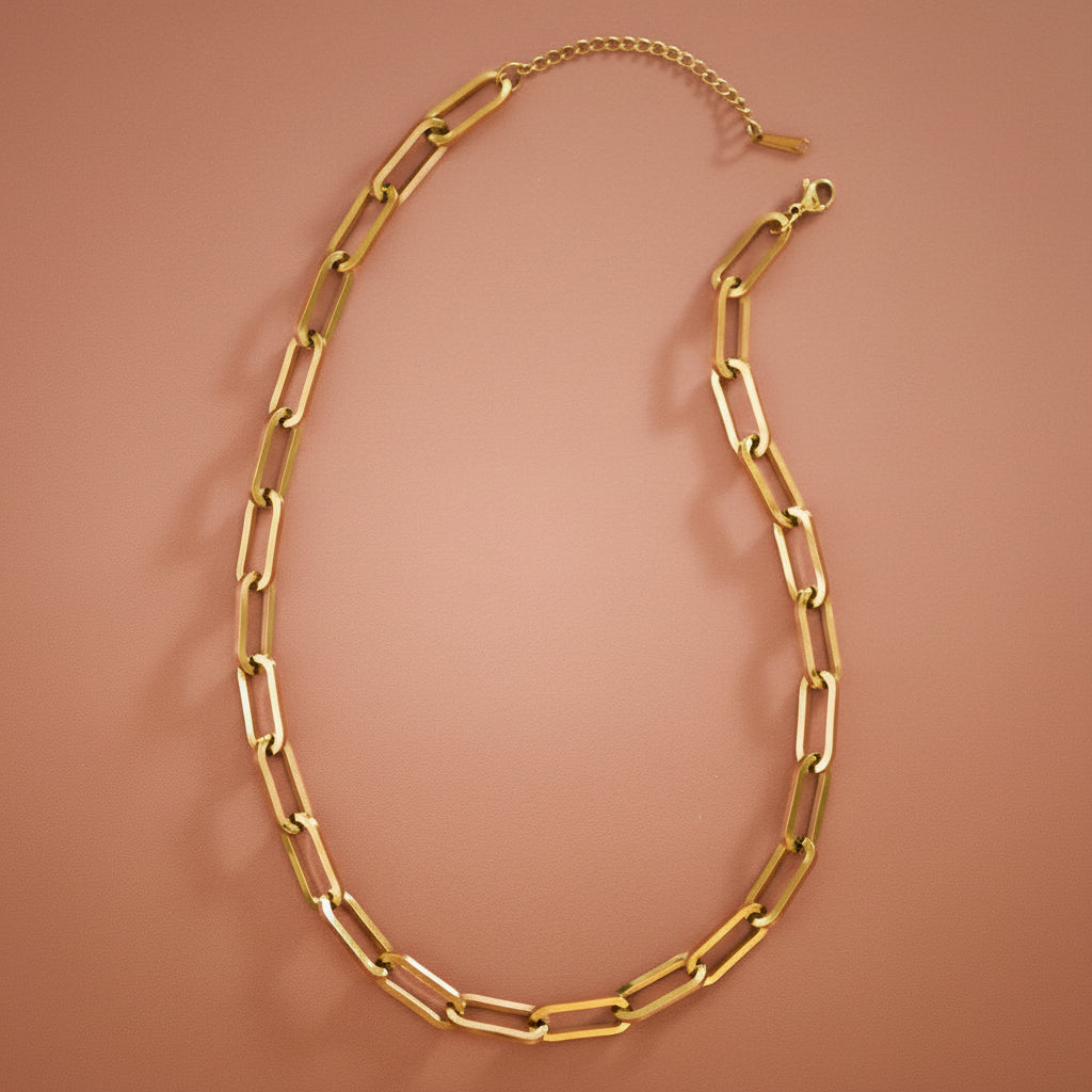 Elevate your everyday style with this striking 18K gold plated stainless steel paperclip chain necklace. Featuring chunky, substantial links that make a bold statement, this 16" necklace includes a 2" extender for customizable length and comfort. Crafted for durability, it's hypoallergenic, waterproof, and tarnish-resistant—perfect for layering or wearing solo. The real gold plating delivers a luxe finish that complements any look, from casual to dressed up.