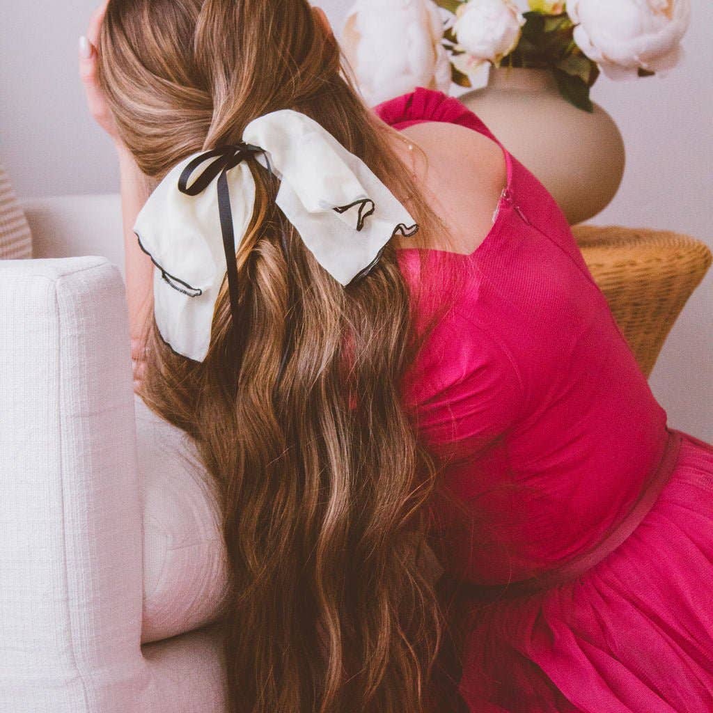 This bow is stunning! Featuring a sheer, cream chiffon bow, with a single satin ribbon bow atop, it sings elegance. The medium-length tail, will blend perfectly with almost any hair length and elevate every outfit and look. 