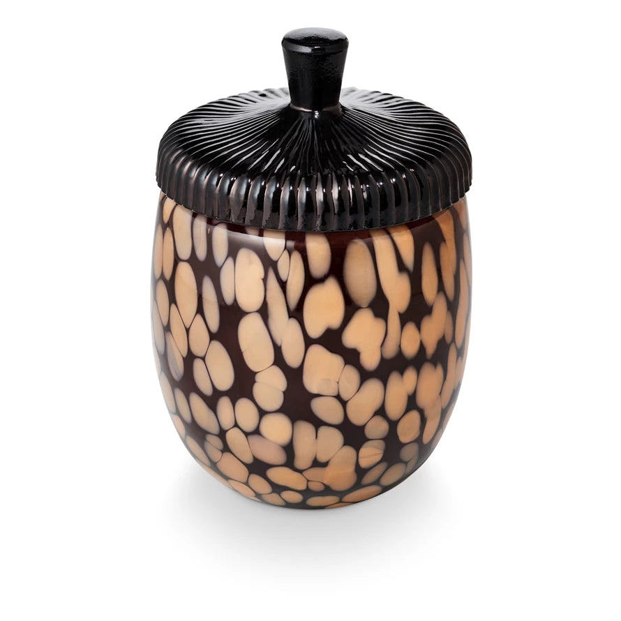 Decorative jar with a black lid on a white background