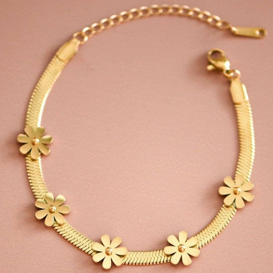 Elevate your everyday style with this stunning 18K gold plated stainless steel chain link bracelet. Crafted with a delicate floral herringbone design, it combines timeless elegance with modern durability. Hypoallergenic and waterproof, this piece resists tarnishing and withstands daily wear, sweat, and moisture. Perfect for layering or wearing solo, it's an effortless addition to any jewelry collection. To maintain its lustrous finish, avoid prolonged contact with lotions, perfumes, and harsh chemicals.