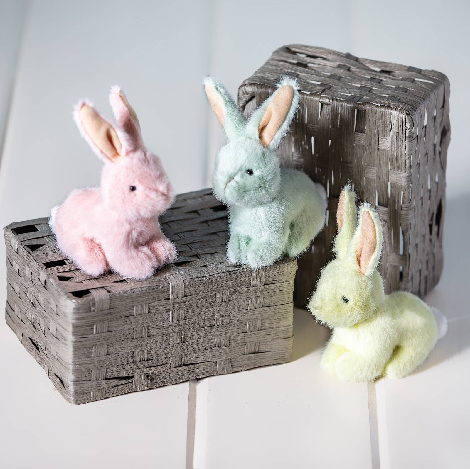 Adorable little crouching bunnies in soft, plush fabric arrive in three charming pastel colors. These petite companions make ideal basket stuffers for Easter celebrations or springtime gifting. Each bunny features a sweet, sitting pose perfect for display or cuddling. Collect all three colors to create a delightful pastel trio.