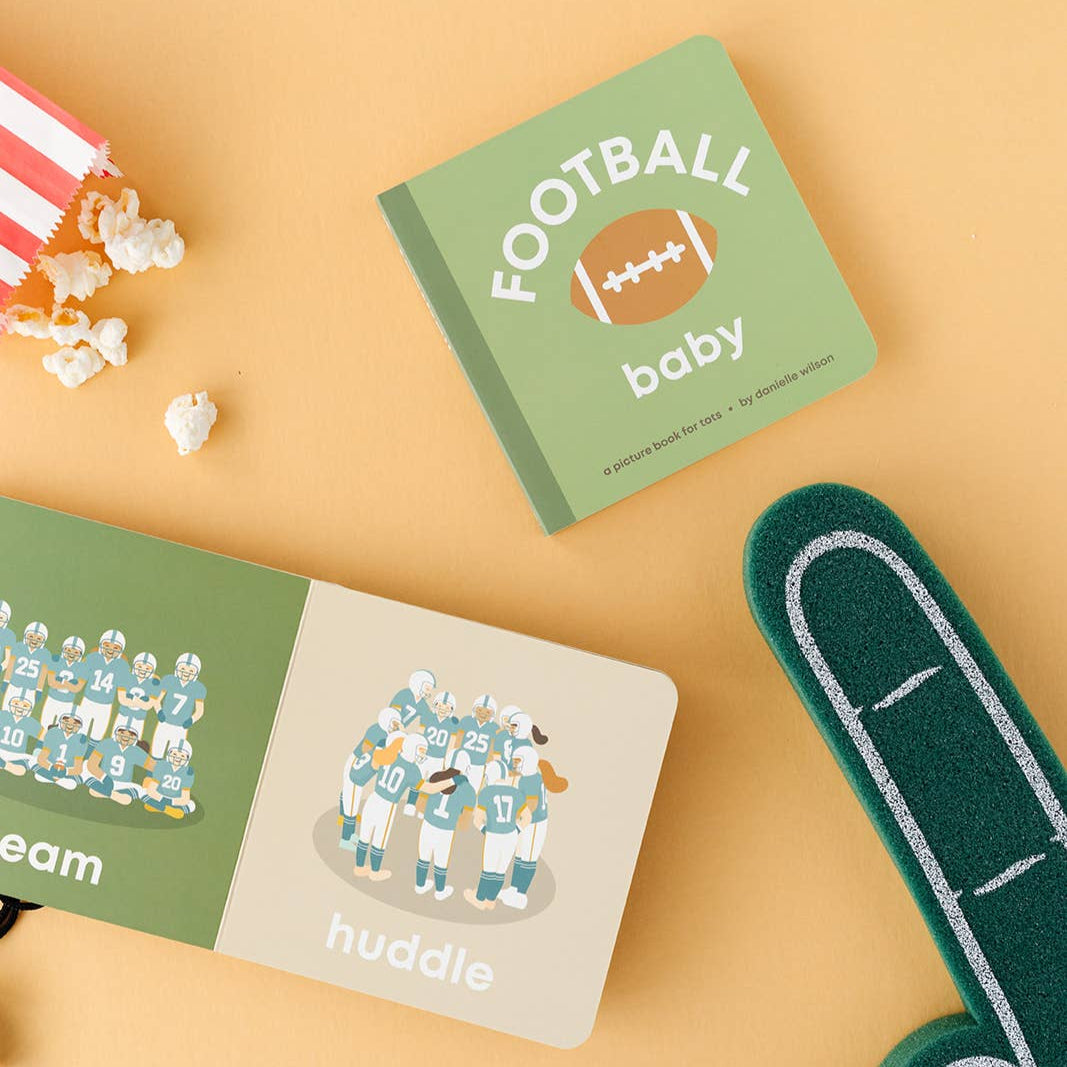 Children's books and foam finger on a yellow background