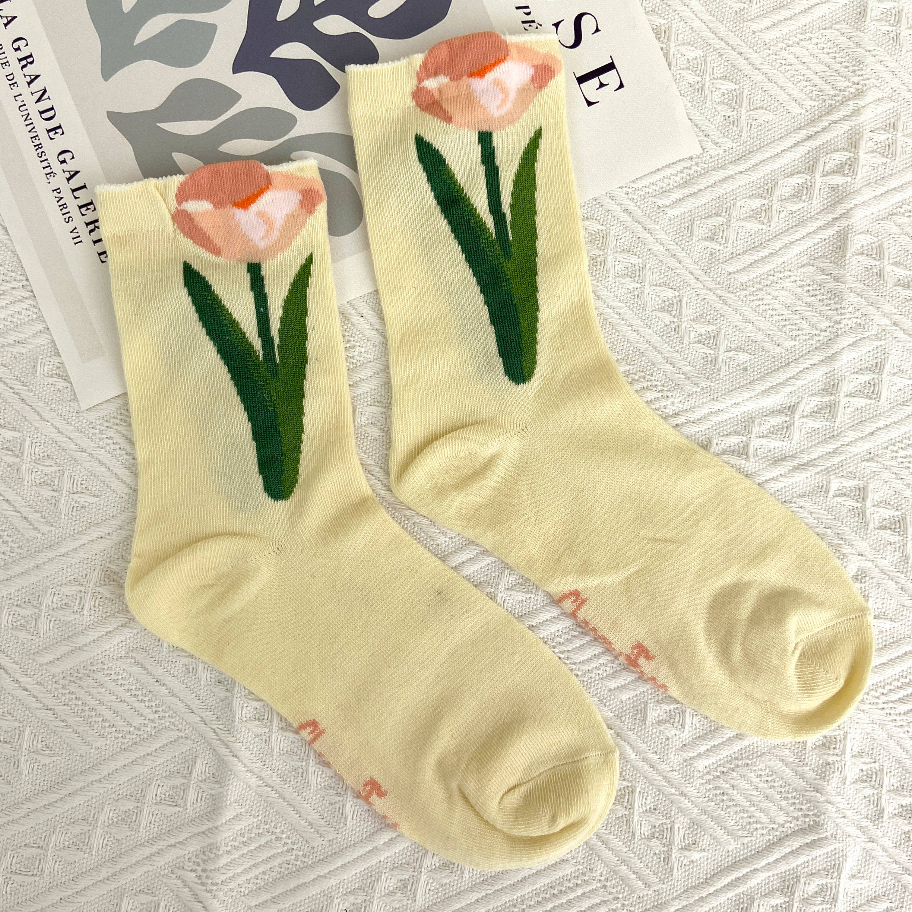 Step into comfort with these charming mid-calf socks featuring a pretty pink tulip pattern on a soft yellow base. The vintage-inspired design brings a touch of timeless elegance to your everyday wardrobe, perfect for adding personality to any outfit. Whether you're dressing up or keeping it casual, these floral socks offer the cozy support you deserve while celebrating your unique style.