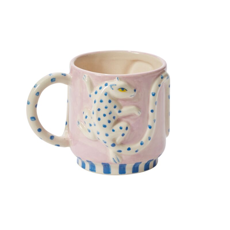 Wildly cute yet perfectly tame, the Wild Tails Leopard Mug adds a little flavor to beverages with its playful design. Featuring a dimensional leopard with a squiggle tail that wraps around as the handle, this food-safe mug makes a delightful addition to tableware with bright color, hand painted details, & organic pattern.