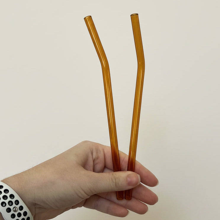 Bent orange straws. 8 inches long.
