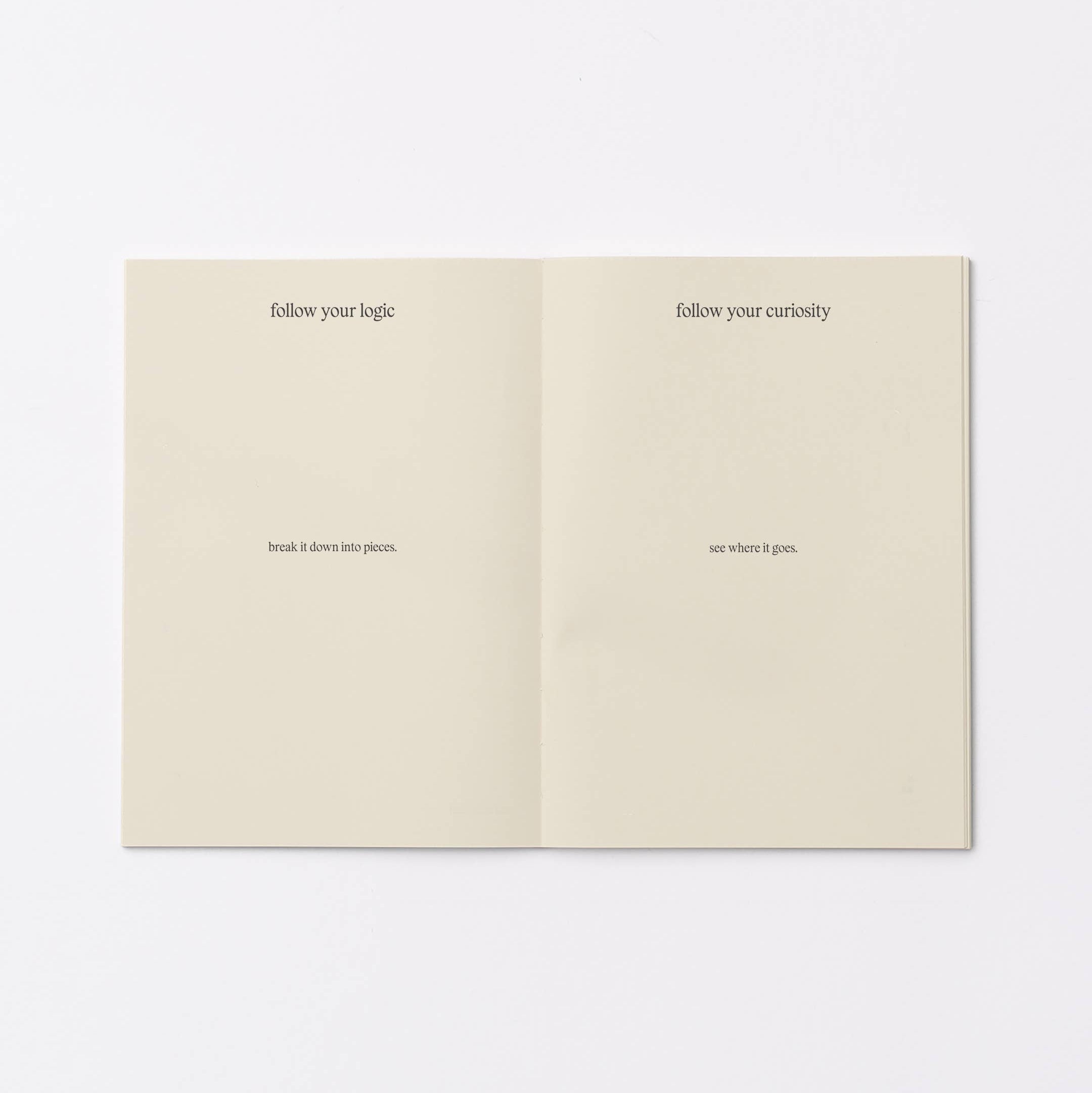 An open booklet or notebook spread on a plain white background, showing two cream-colored pages with small black printed text.