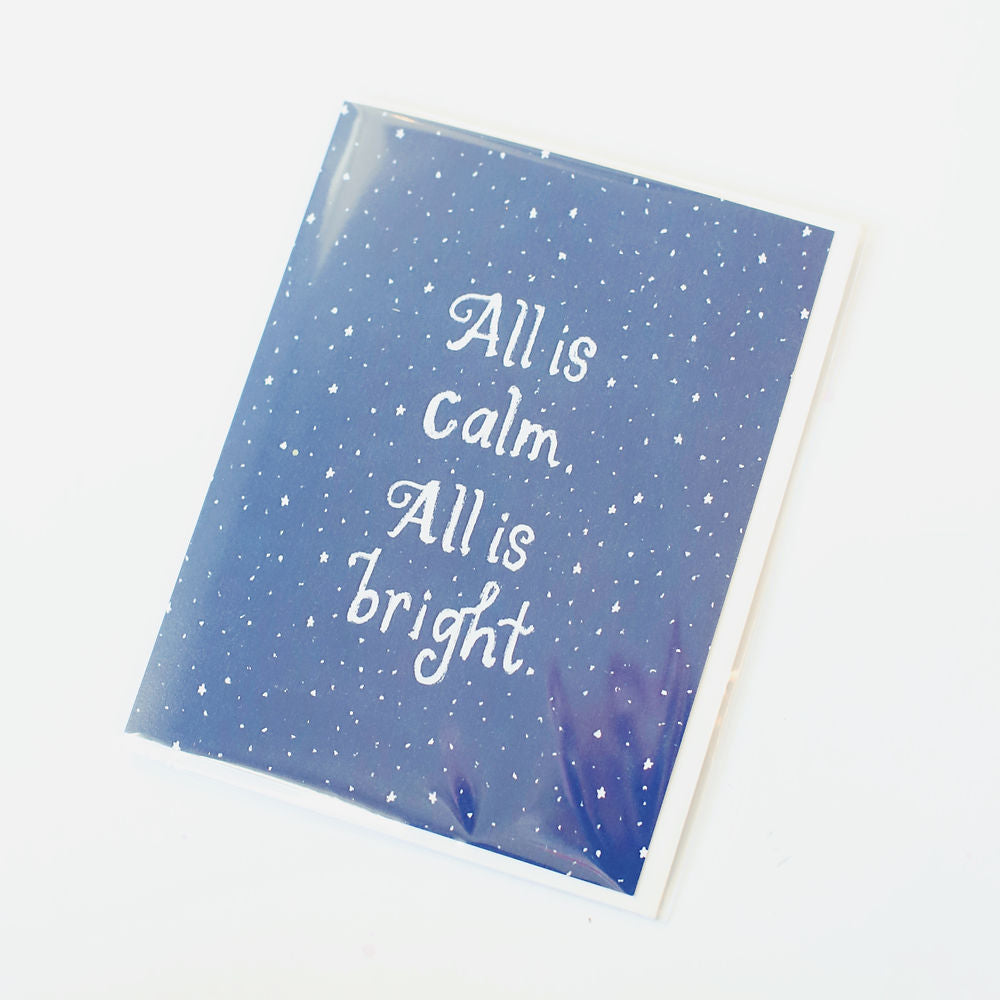 Dark indigo card with tiny white stars and white words. Pictured against a white back ground.