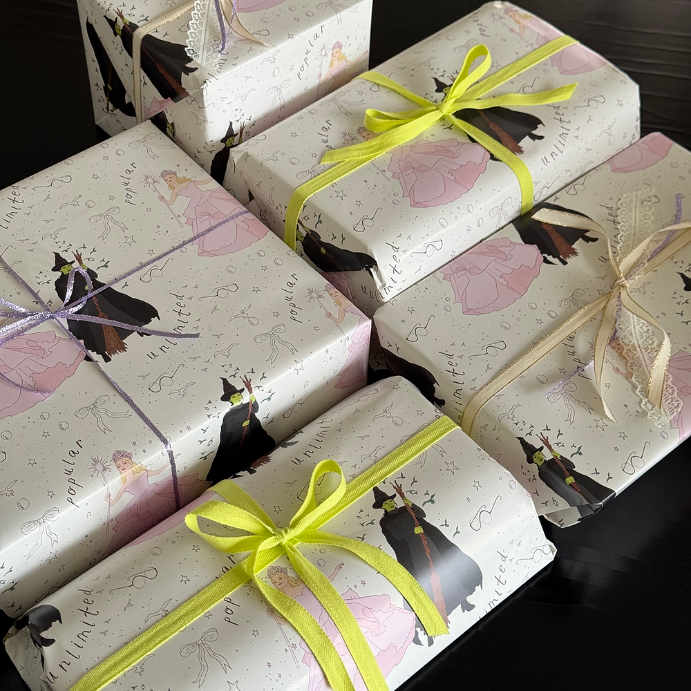 wrapping paper displayed on various sizes of boxes with cute coordinating ribbons.