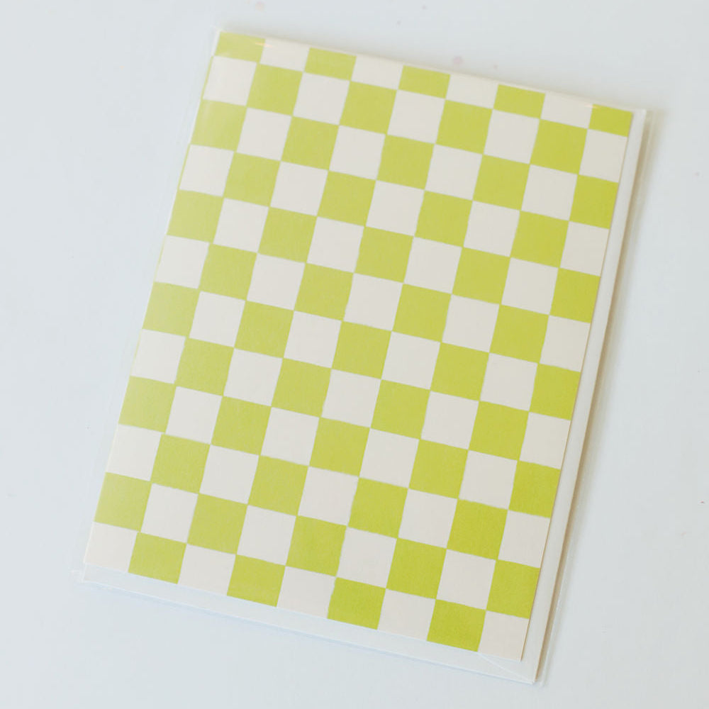 Checkered lime green and white card, pictured against a white back ground.
