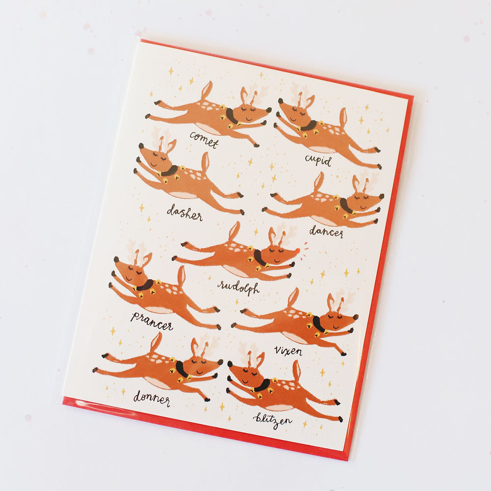 White card with all of Santa's reindeer represented with stars and sparkles. Pictured against a white back ground.