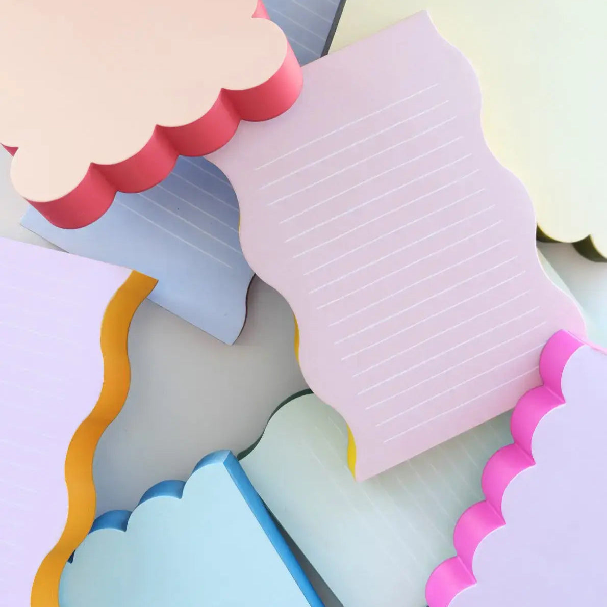 Colorful paper cutout shapes on a light gray background