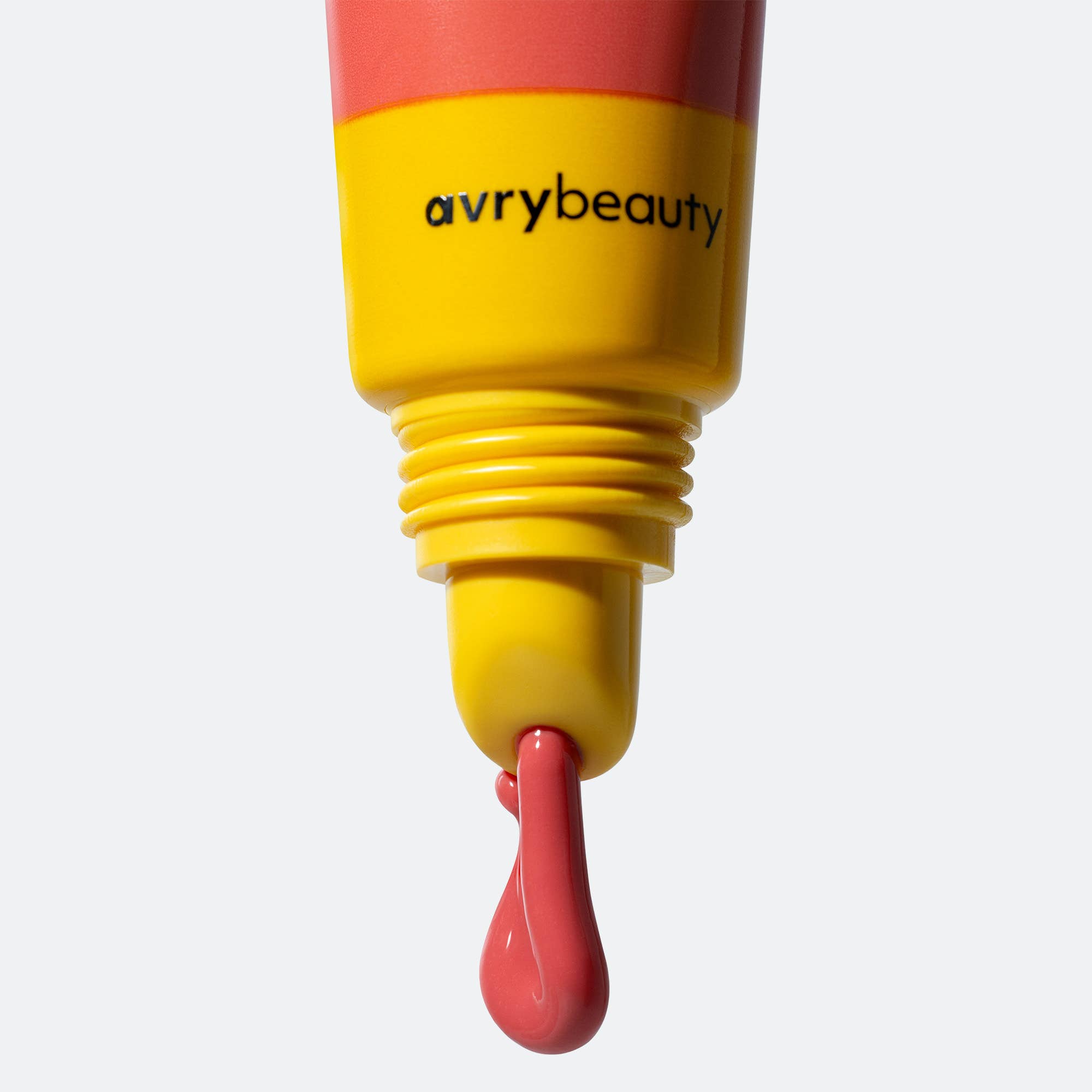 Yellow and red cosmetic product with 'avrybeauty' branding on a white background
