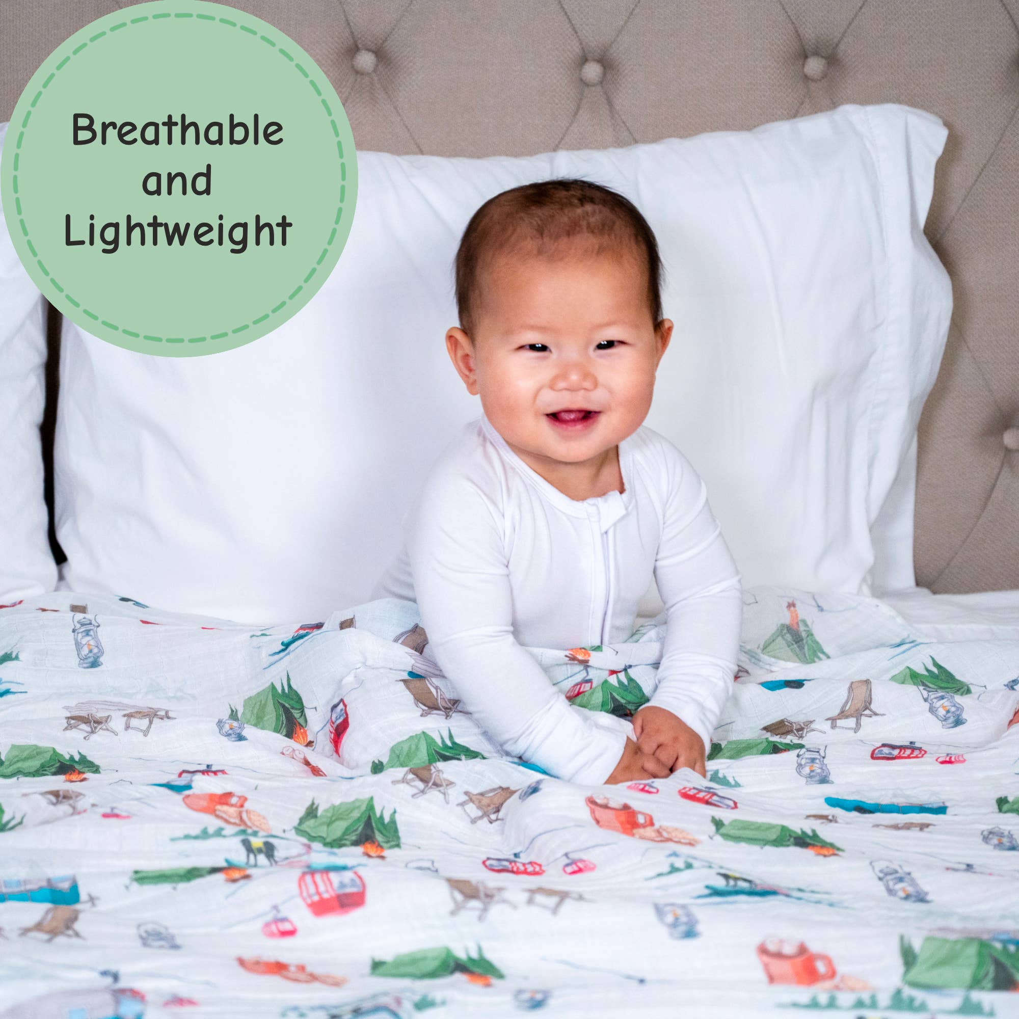 Baby sitting on a bed with colorful bedding, surrounded by pillows.