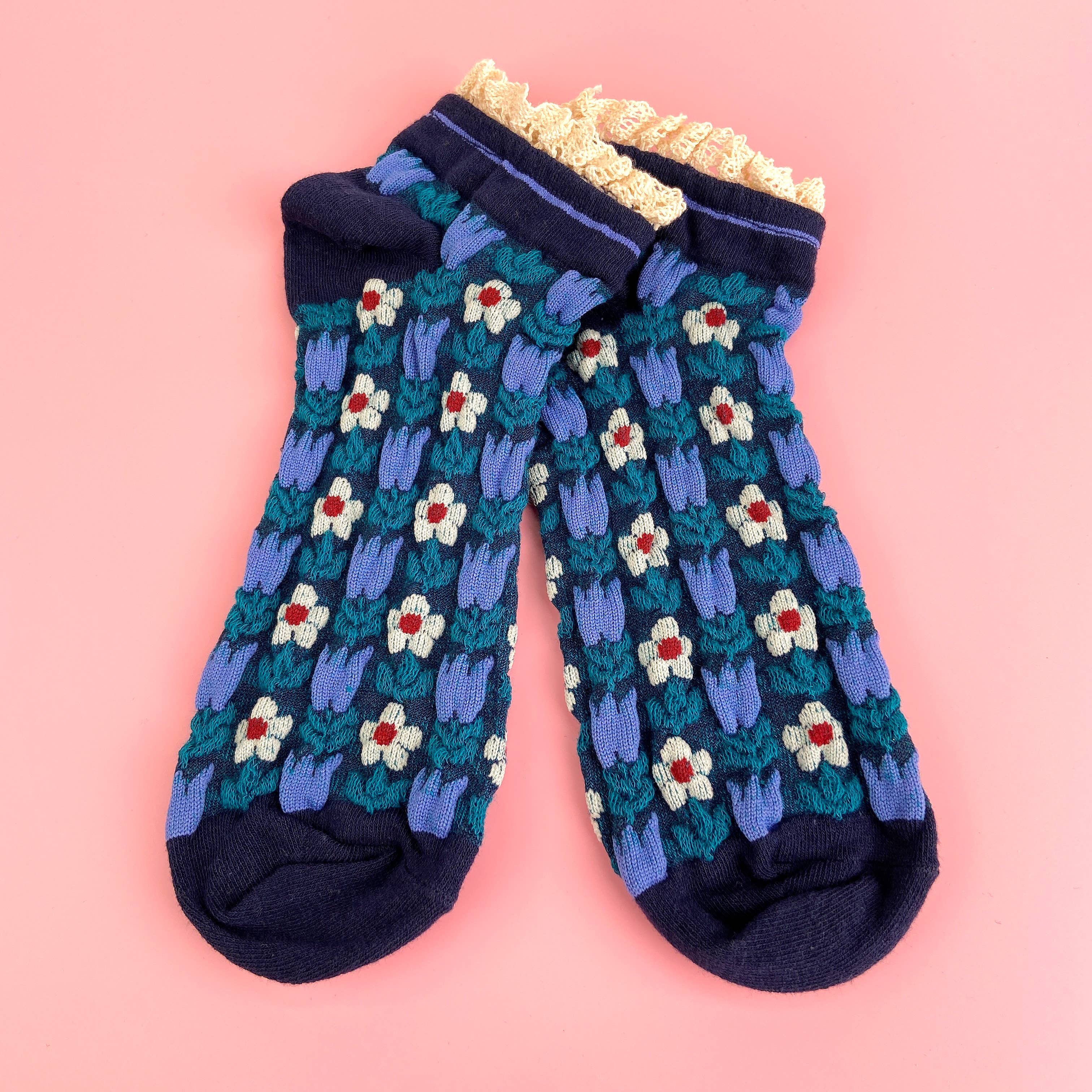 Step back in time with these charming Blue Retro Court Style Floral Lace Socks. Featuring a nostalgic floral pattern in soft blue tones, these socks bring vintage-inspired style to your everyday wardrobe. The delicate lace ruffle edge adds a touch of elegance and femininity, making them perfect for anyone who loves classic aesthetics. Whether you're pairing them with sneakers, loafers, or Mary Janes, these socks celebrate timeless fashion with a playful twist.