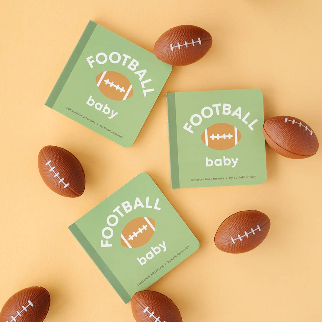 Three green 'Football Baby' books surrounded by small brown football-shaped toys on a beige background