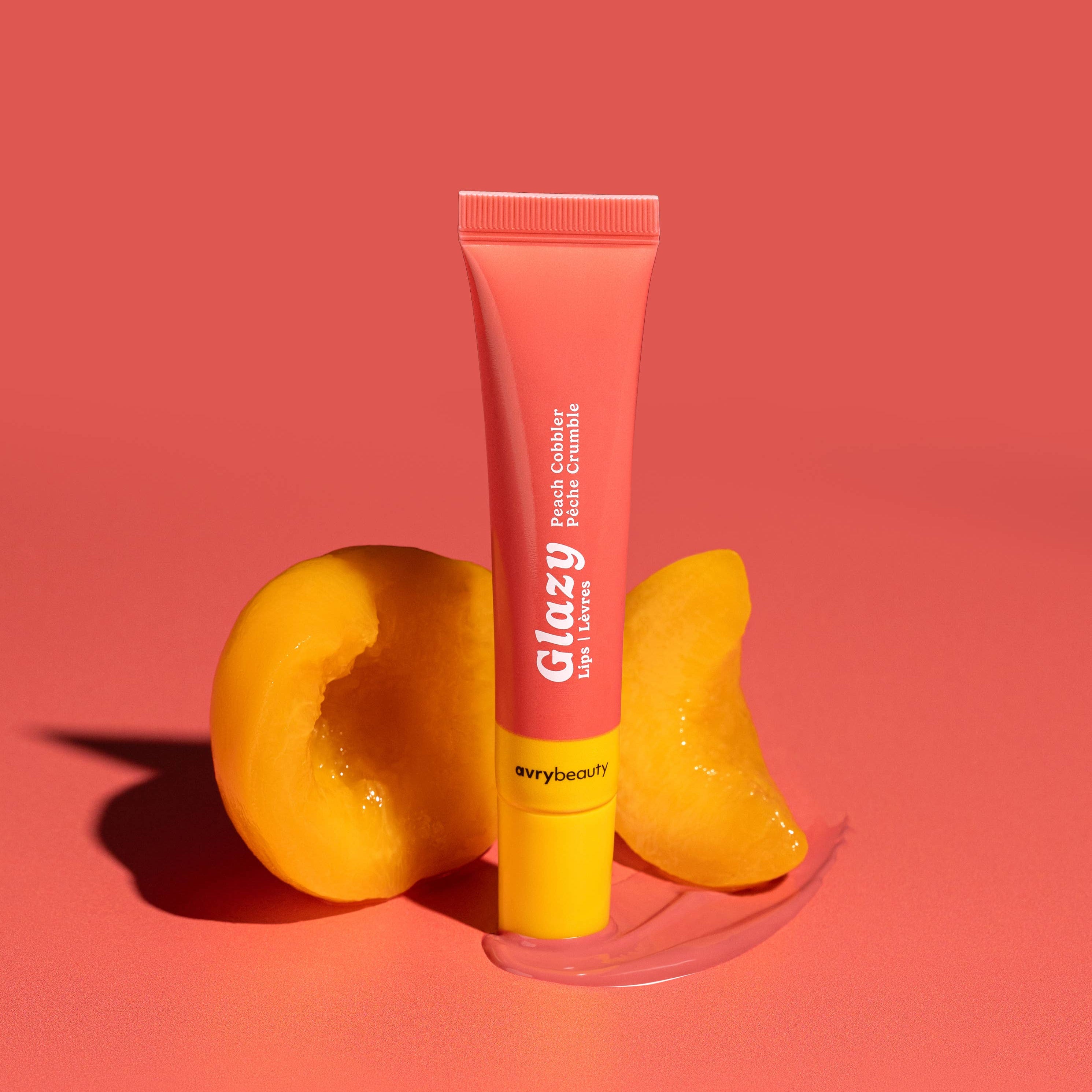 Pink lip balm tube with 'glazy' branding on a pink background