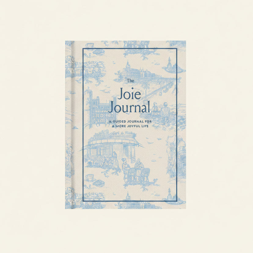 Bring that je ne sais quoi to the everyday with The Journal of Joie.
Paris-based author Ajiri Aki has always embraced that French joie de vivre, the idea that all aspects of life can be made more enjoyable, and with this journal she teaches readers to cultivate a mindset around joie. Whether it's buying yourself flowers, finding ways to slow down and savor, hosting a small gathering, or taking a trip down memory lane, this journal provides small challenges that will help you bring more joy into life.